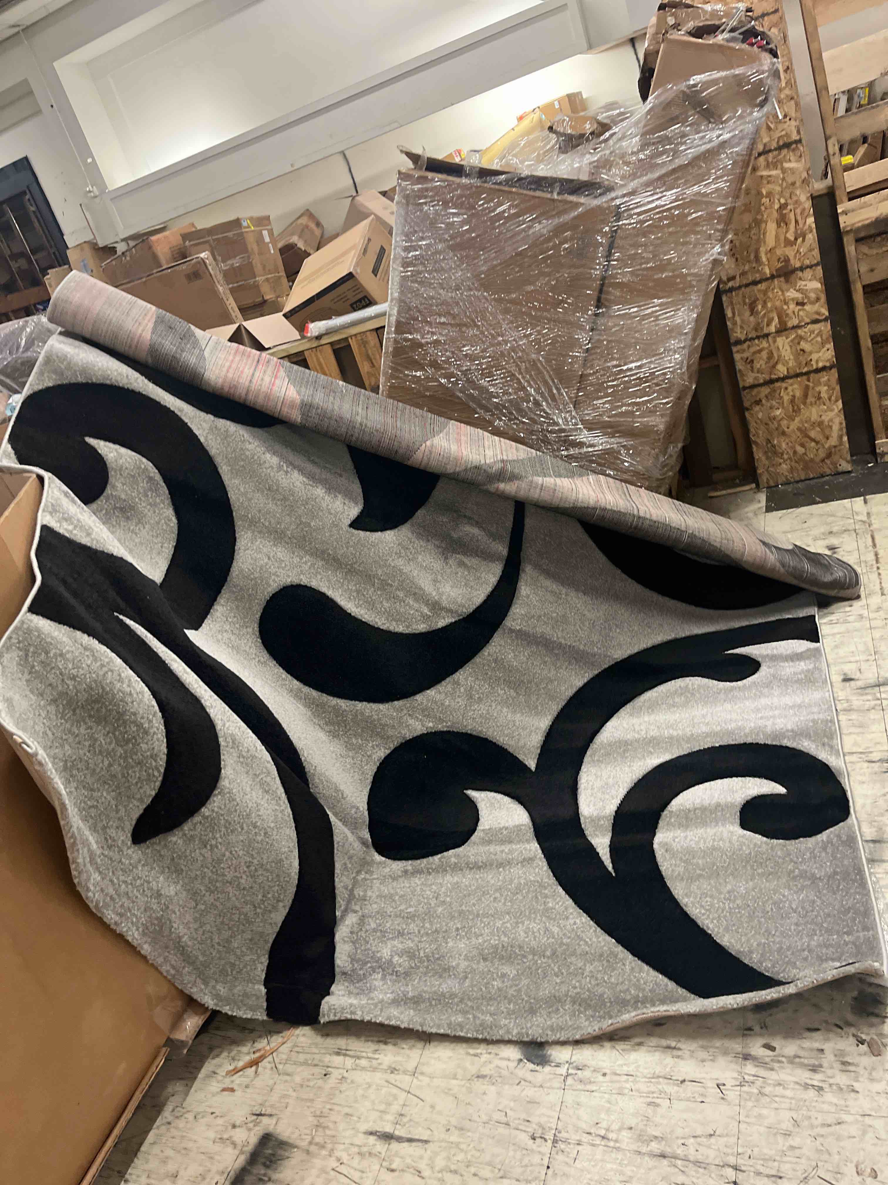 Condition photo showing New/Like New for paco home grey black area rug with contour cut and modern floral pattern, size: 6'7" x 9'6"