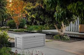 Condition photo showing New/Like New for keter westwood 150 gallon resin large outdoor storage box for patio furniture, outdoor cushions, garden tools and pool floats, light grey