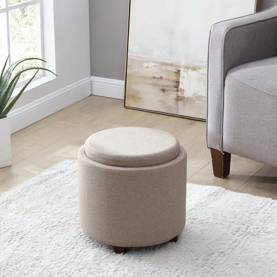 grey round storage ottoman with smaller ottoman inside