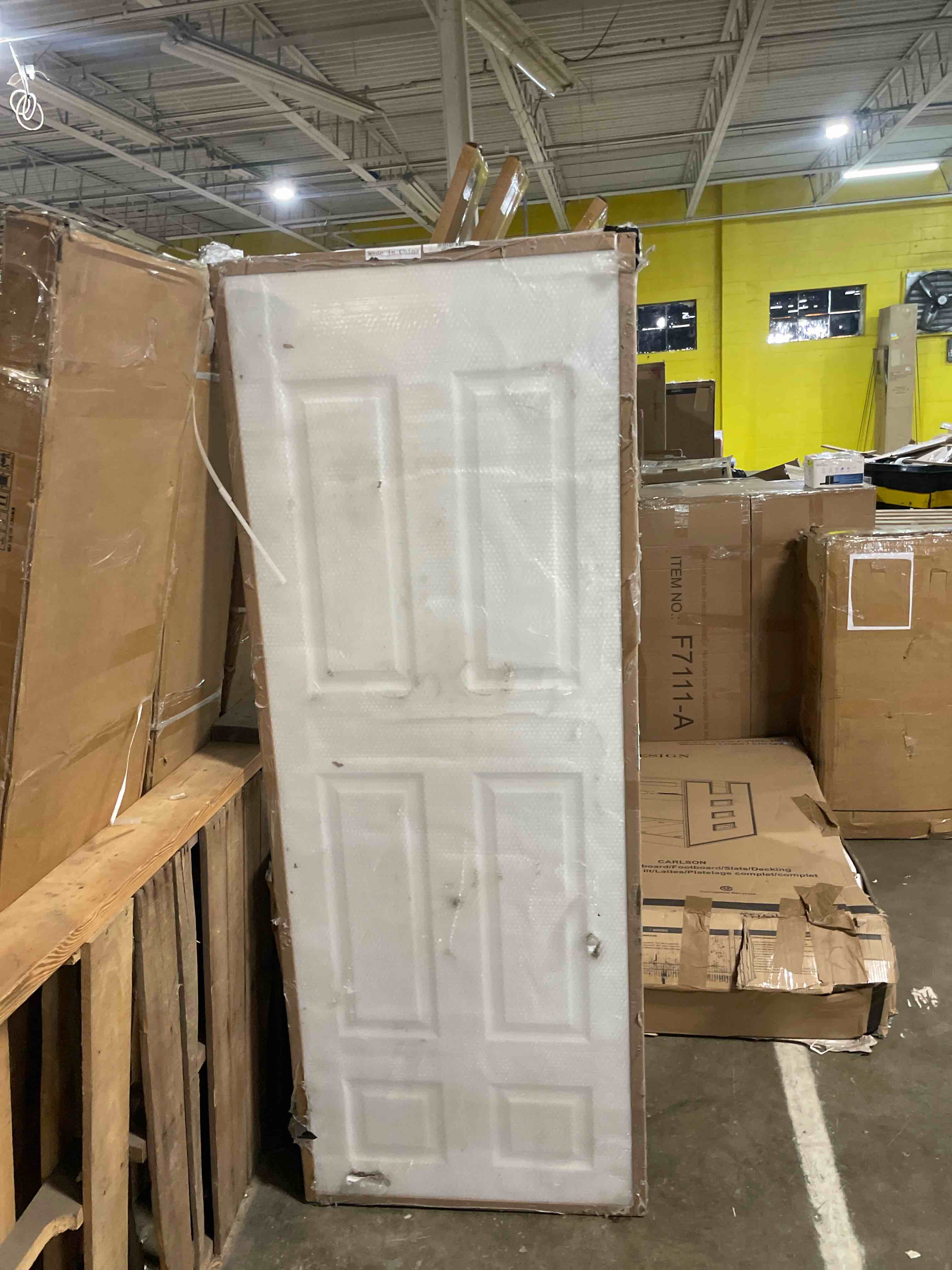 Condition photo showing As Is for barnsmith 30x80 in raised 6-panel textured white primed molded door slab, classic style paintable hollow core interior door panel, for pocket, swing, sliding door, durable and lightweight 30" x 80" (damaged)