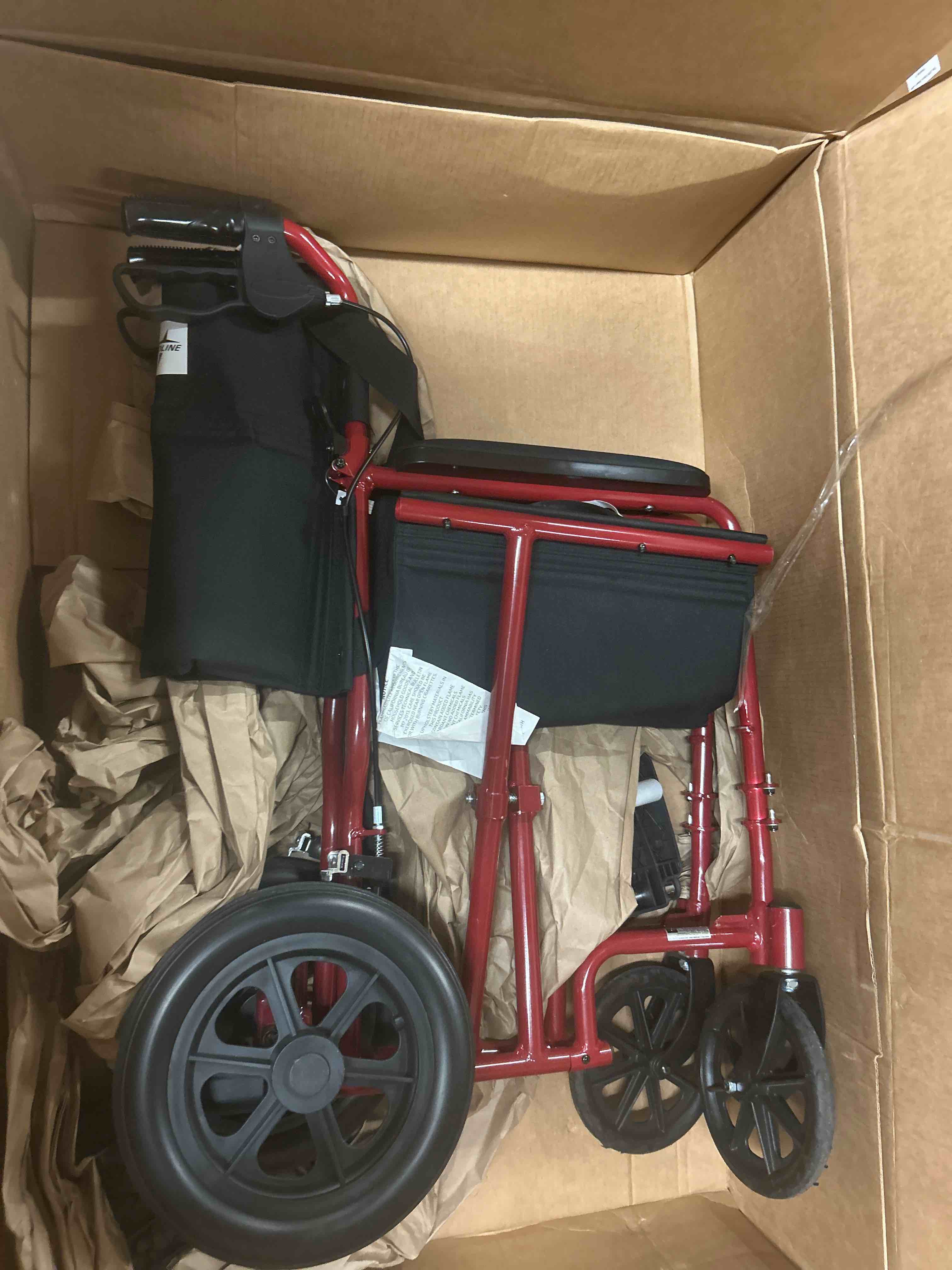 Condition photo showing New/Like New for medline lightweight foldable transport wheelchair with handbrakes and 12-inch wheels, red frame, black upholstery