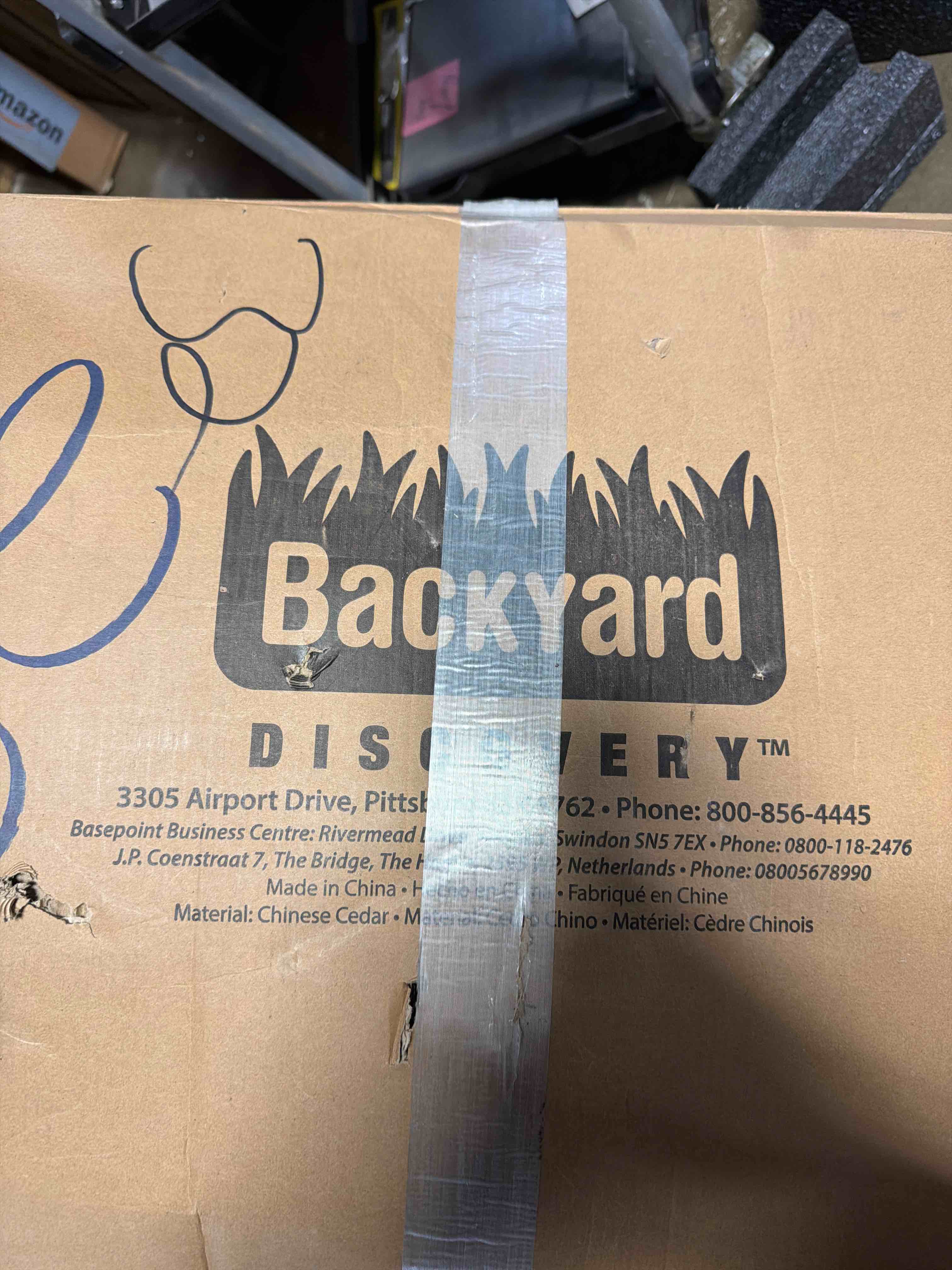 Condition photo showing New/Like New for backyard discovery buckley hill cedar wood swing set with wave slide, play deck, rock wall ladder, belt swings, chalkboard, canopy roof, outdoor playset, box is slightly damaged.