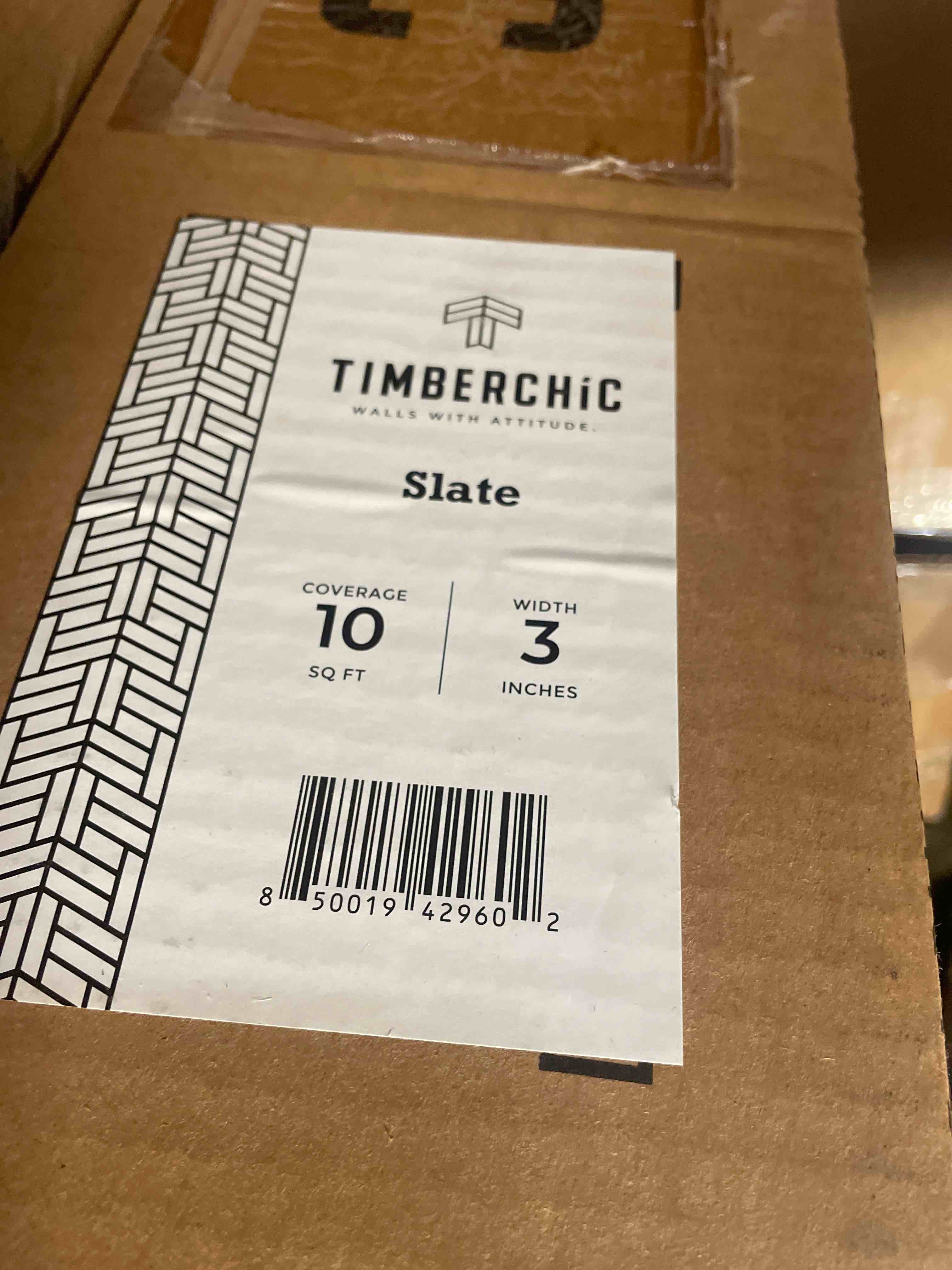 Condition photo showing New/Like New for 1/8 in. x 3 in. x 12-42 in. oak peel and stick dark gray wooden decorative wall paneling (10 sq. ft./box)