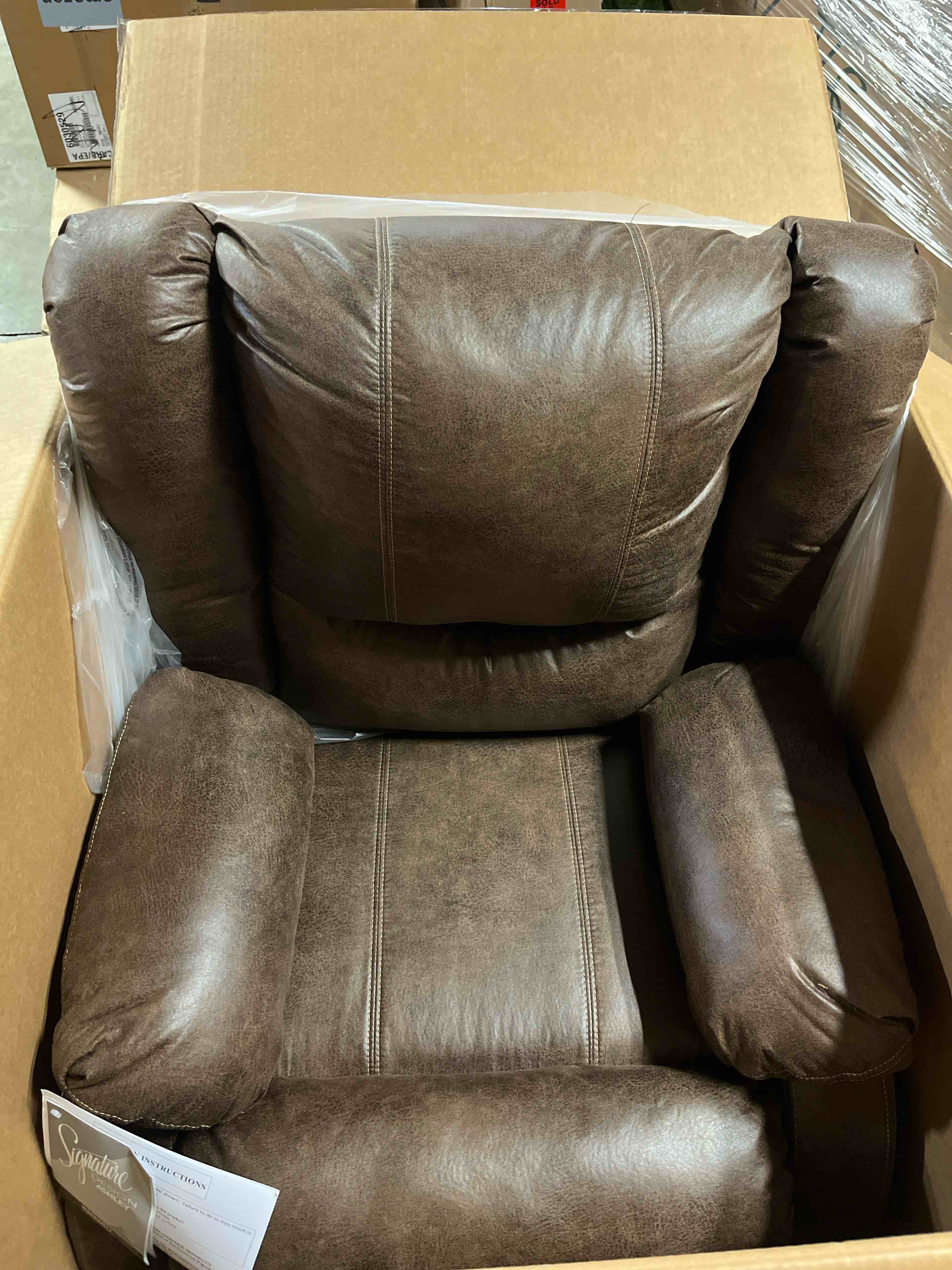 Condition photo showing New/Like New for Signature Design by Ashley Bladewood Faux Leather Pebble Manual Zero Wall Recliner, Brown