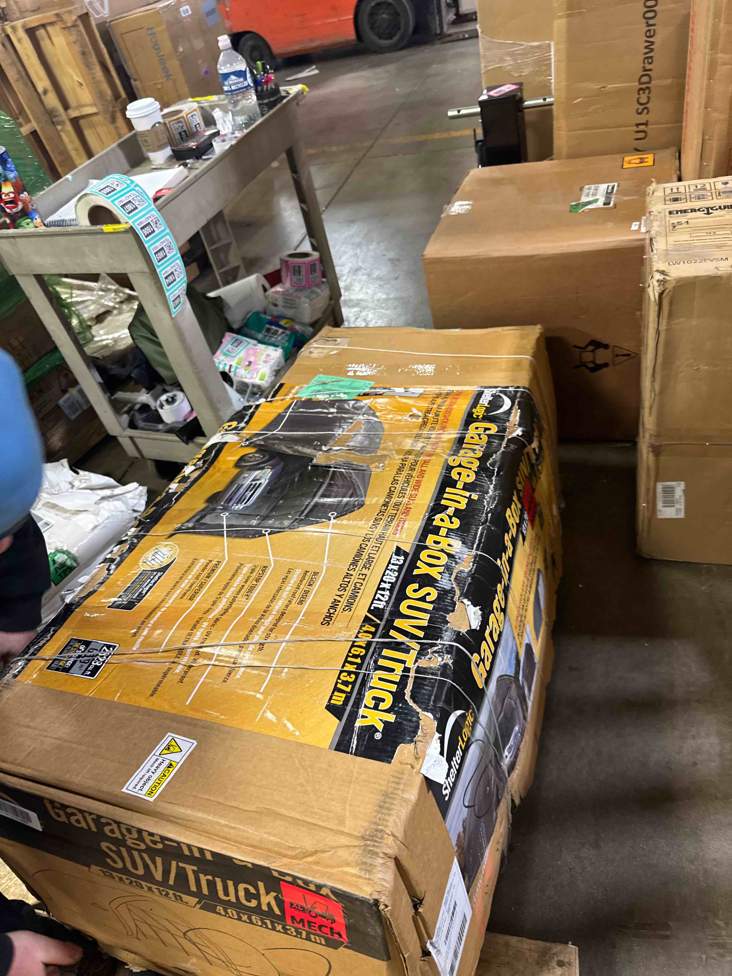 Condition photo showing New/Like New for shelterlogic garage-in-a-box portable outdoor garage for suv and full-size trucks, all-season car canopy carport with alpine style roof, 13' x 20' x 12', gray