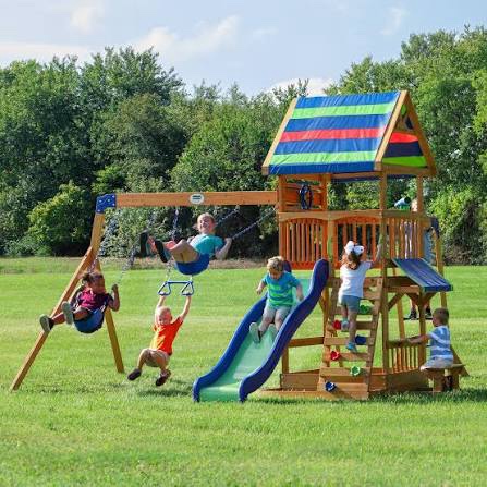 backyard discovery beach front all cedar wooden swing set with monkey bars, large upper deck with canopy, ships wheel, play telescope, sandbox, snack bench, rock wall