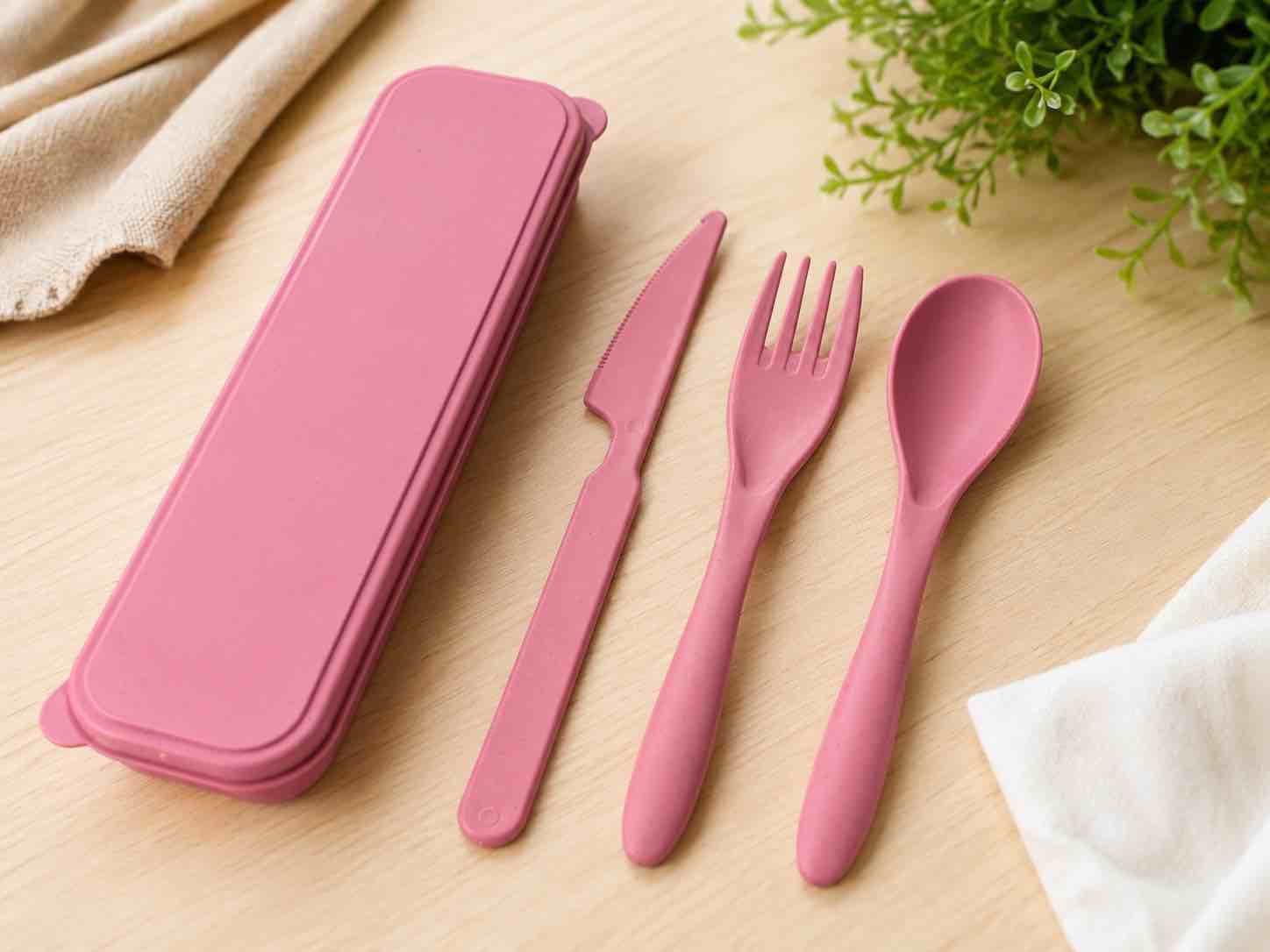 reusable pink travel cutlery set featuring a durable storage case, spoon, fork, and knife—perfect for school, work, camping, and everyday eco-friendly dining.