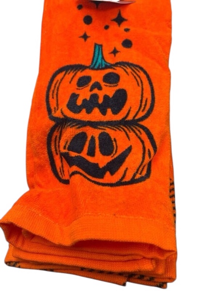 halloween hand towel with a black jack-o'-lantern design