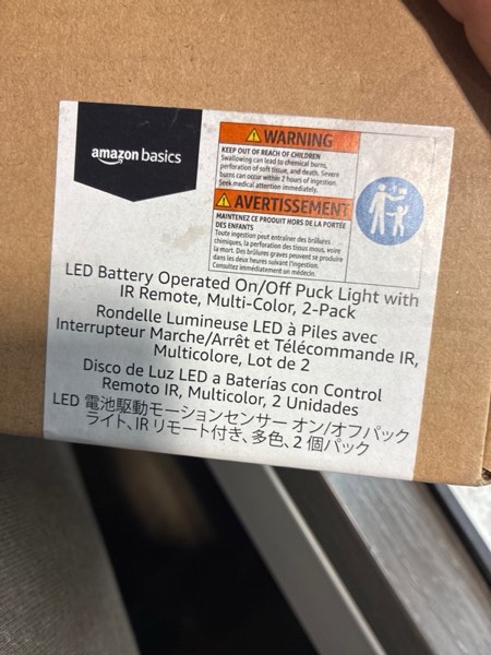 Condition photo showing New/Like New for Amazon Basics LED Puck Lights, Color Changing, Battery Operated, IR Remote, 40 Lumens, 2 Pack, Wireless Stick on Lights, Under Cabinet Lighting, Ideal for Closets, and More, White Motion Sensor Puck Light with IR Remote