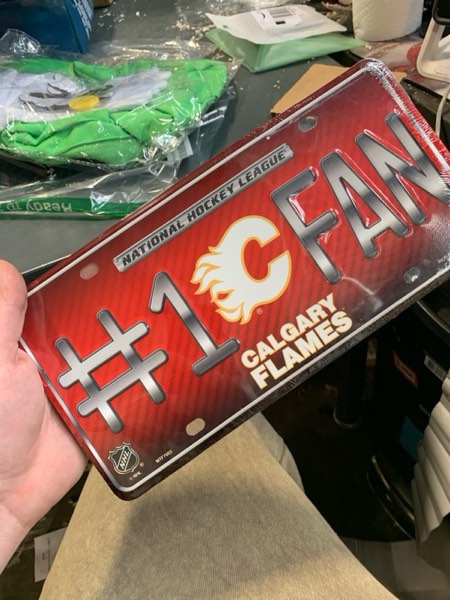 Condition photo showing New/Like New for Rico Industries NHL Unisex-Adult #1 Fan Metal License Plate Tag Calgary Flames 12" x 6" Team Color