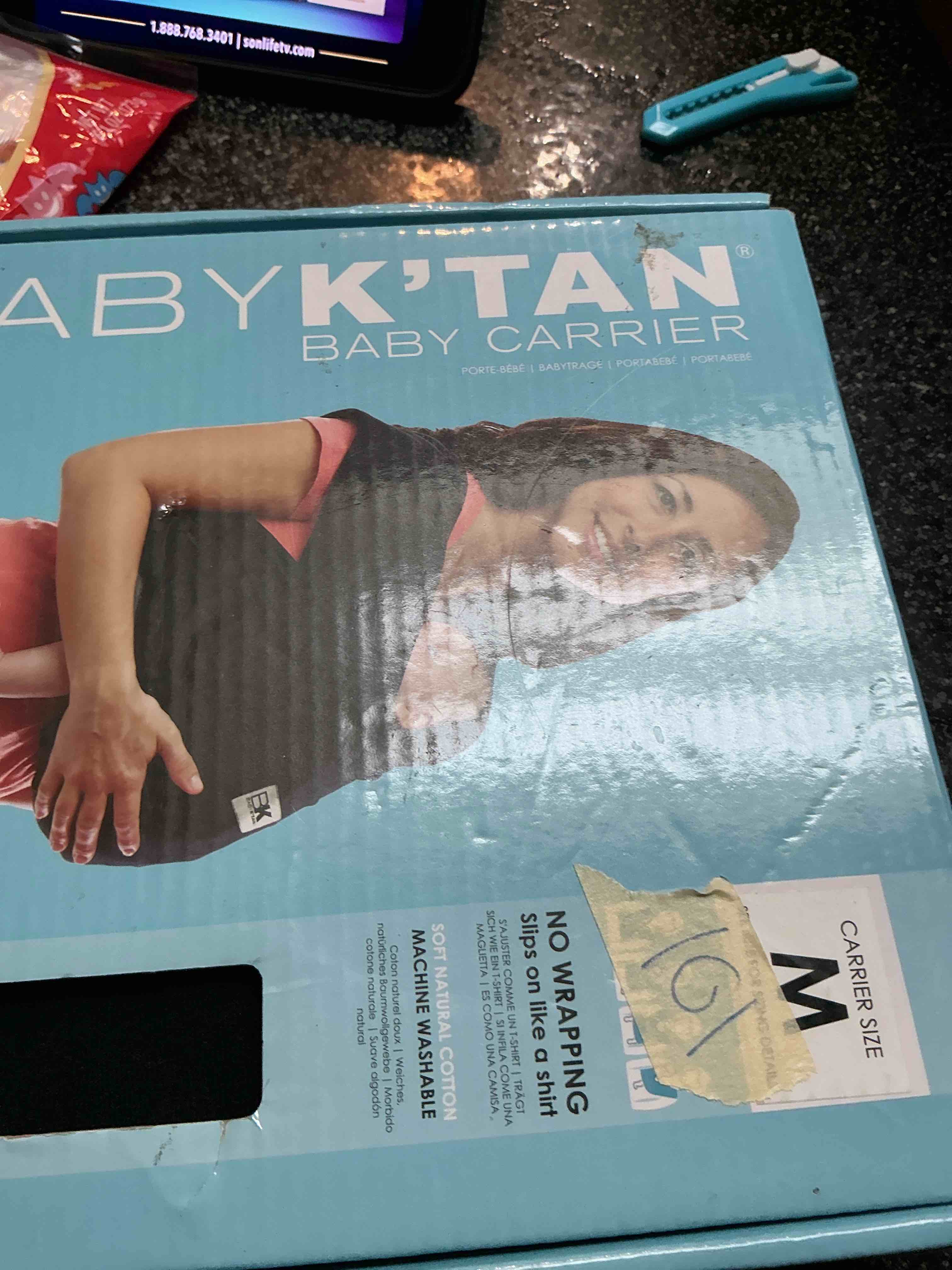 Condition photo showing New/Like New for Baby  K” Tan Baby Carrier Size M 