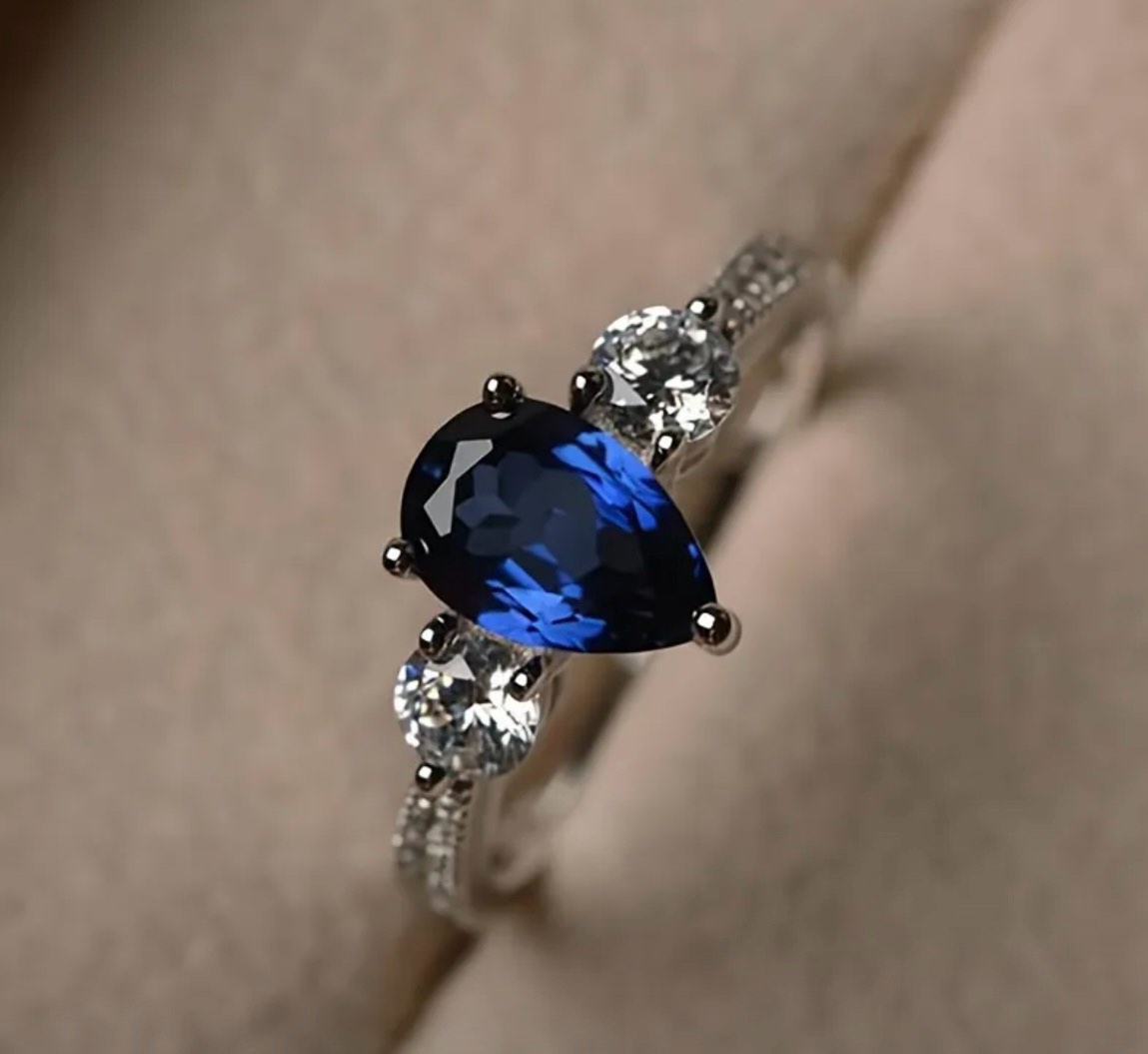 SILVER RING WITH TEARDROP BLUE STONE AND ACCENTS (Size 9)