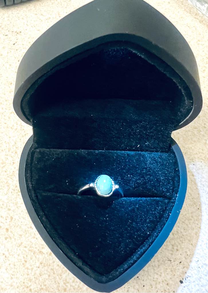 A 925 silver plated  ring featuring an oval blue stone Size 7
