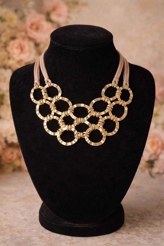 Condition photo showing New/Like New for Bold 18k gold plated necklace featuring layered hammered rings on soft beige suede cords. 