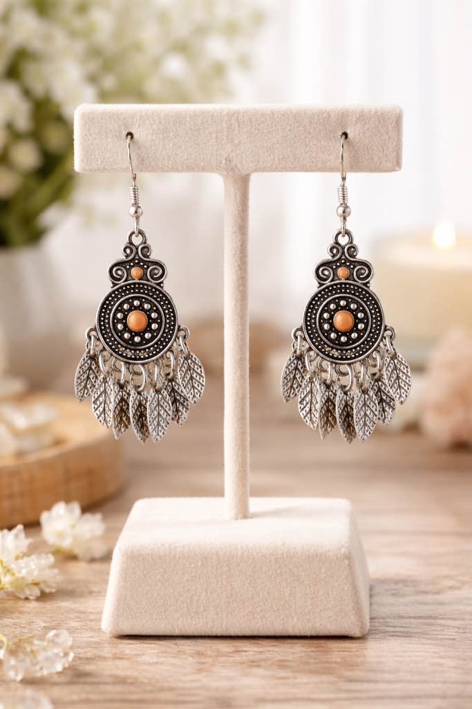 Beautiful 925 Silver plated boho dangle earrings with a peach center bead and feather accents