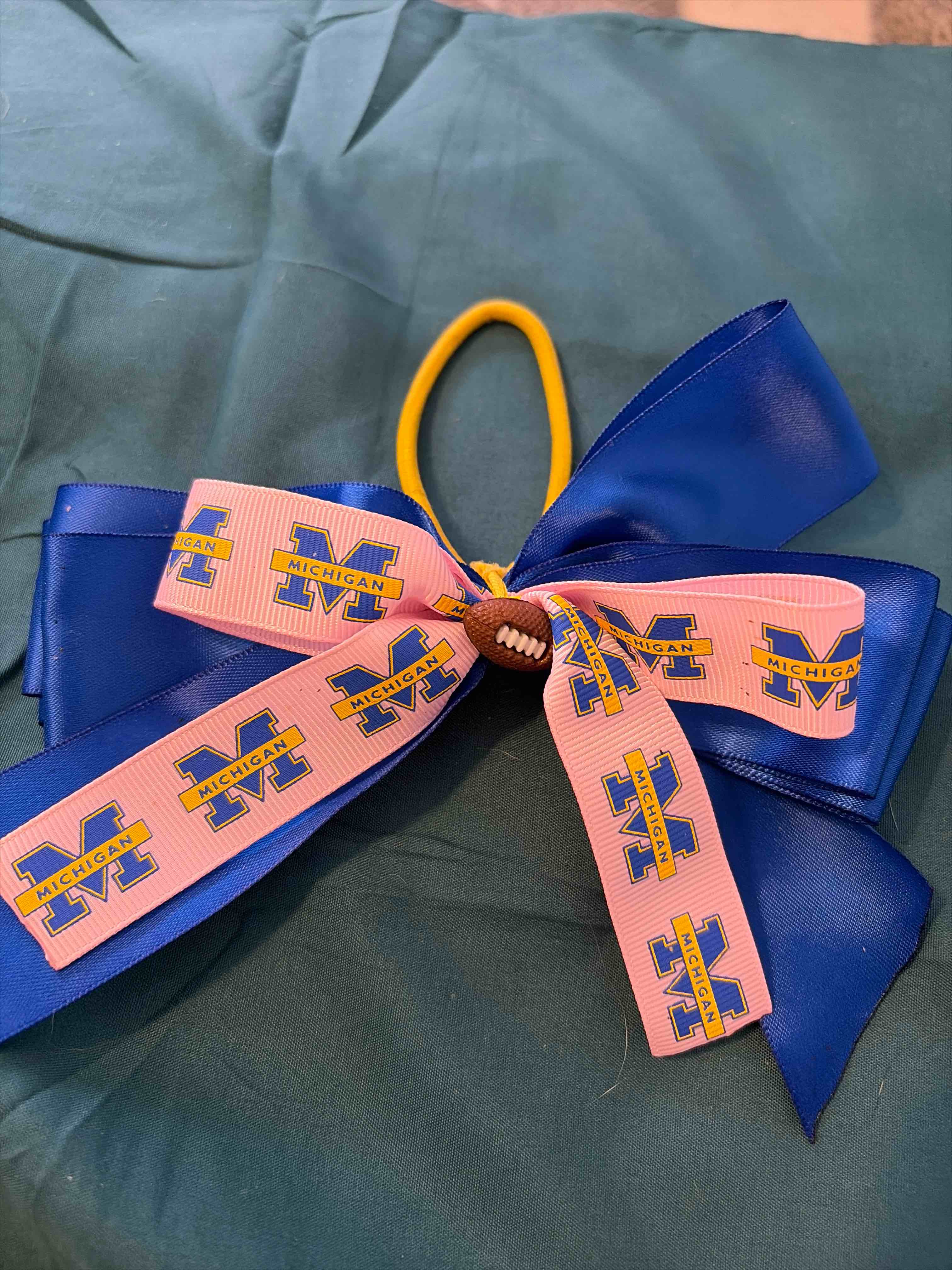 Condition photo showing New/Like New for Michigan hair bow. football.