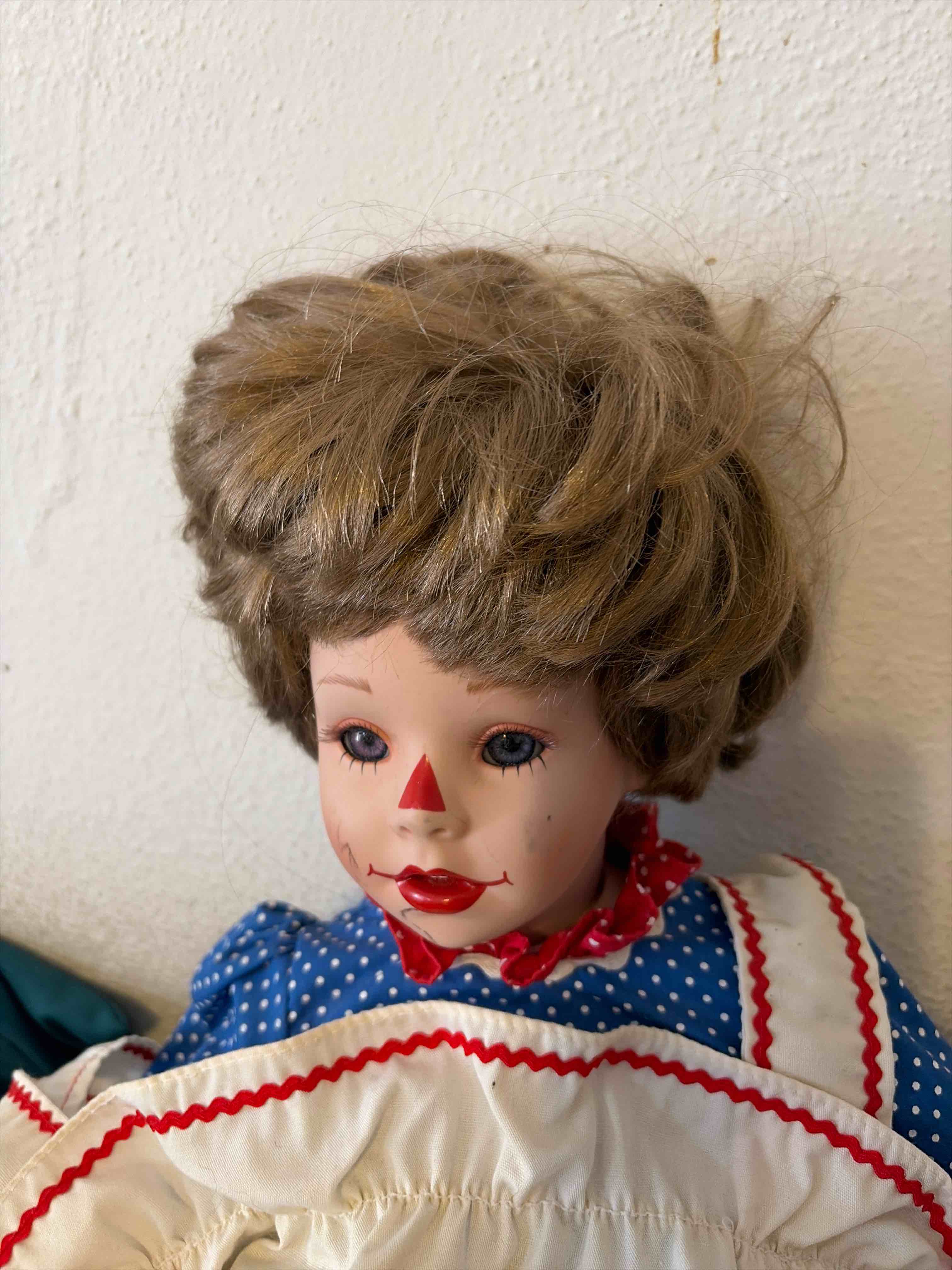 Condition photo showing As Is for porcelain Raggedy Ann doll made by Kelly Rupert 