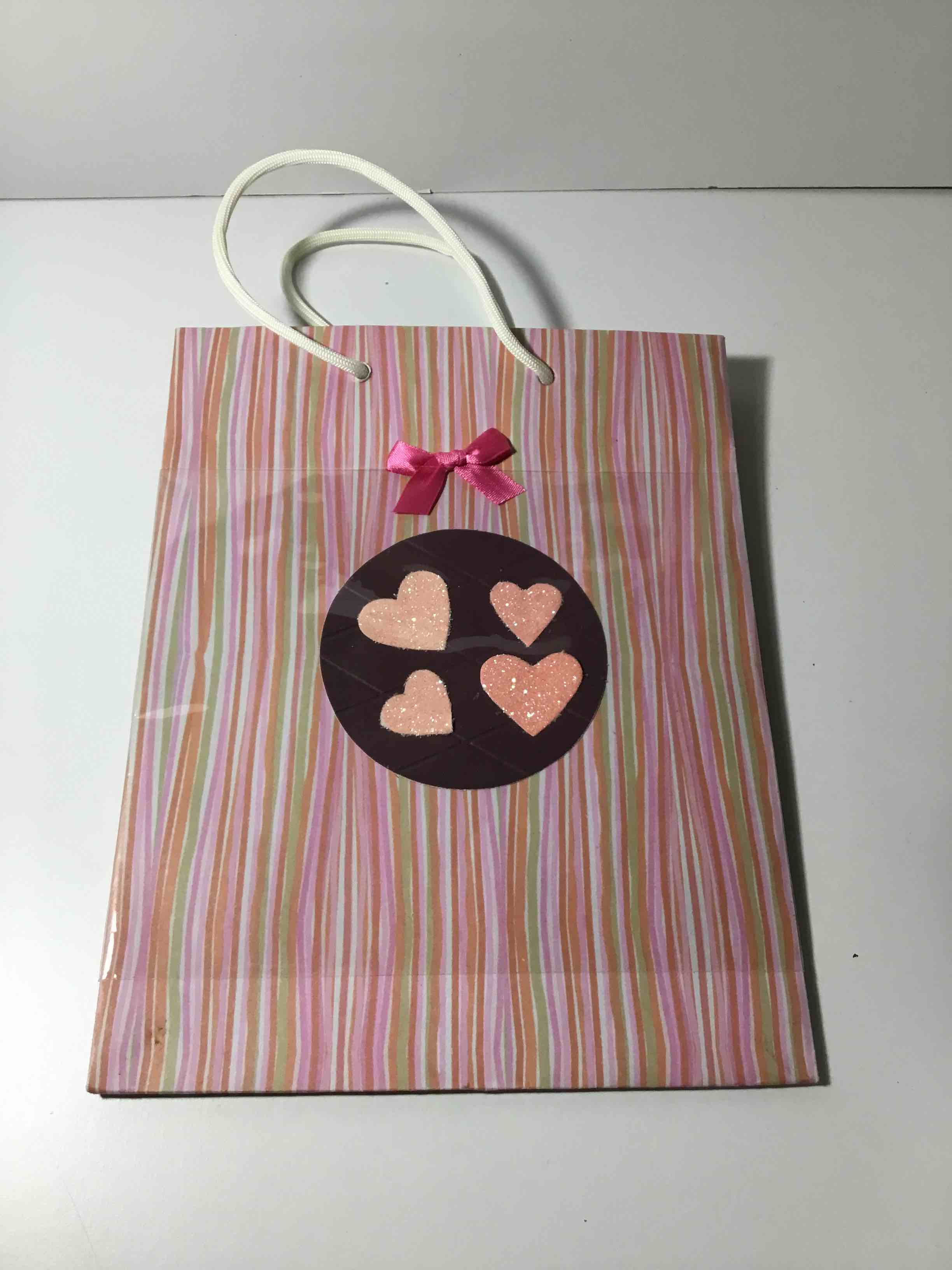 Gift bag with a striped pattern and a heart-shaped tag