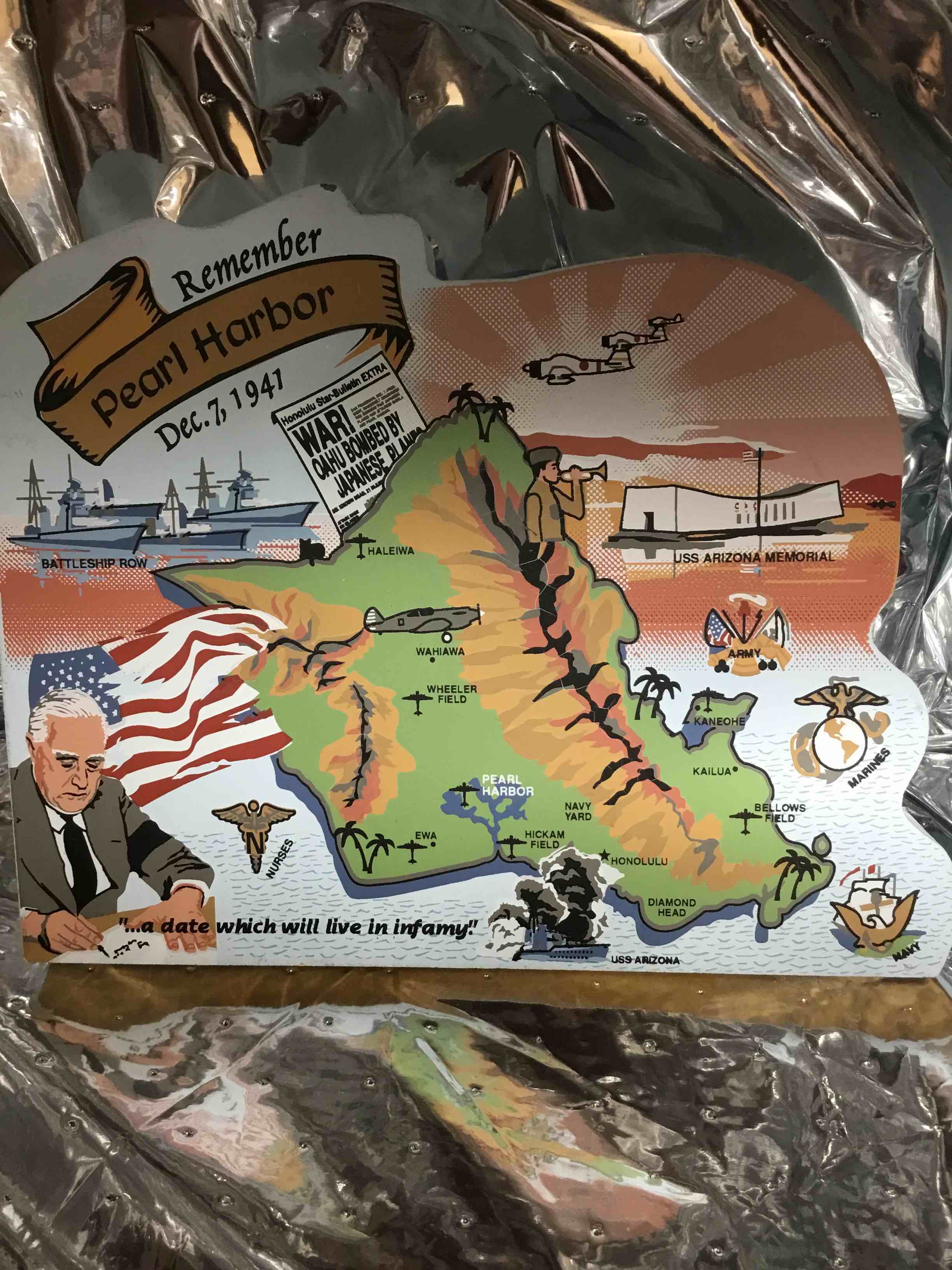 This is a commemorative wooden plaque about the attack on Pearl Harbor, created by The Cat's Meow Village. 