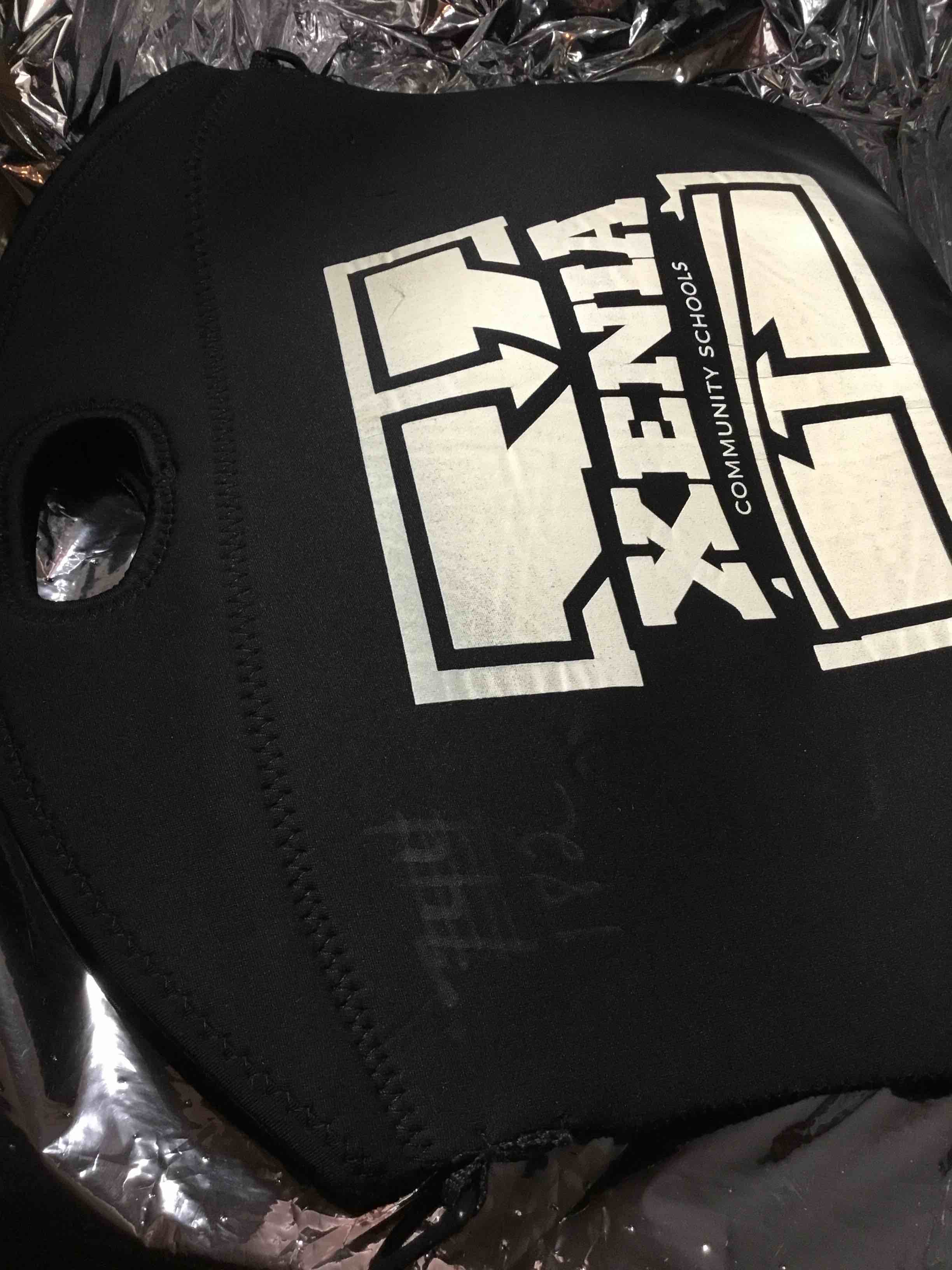 Black  zippered computer bag with a white logo for Xenia Community Schools.