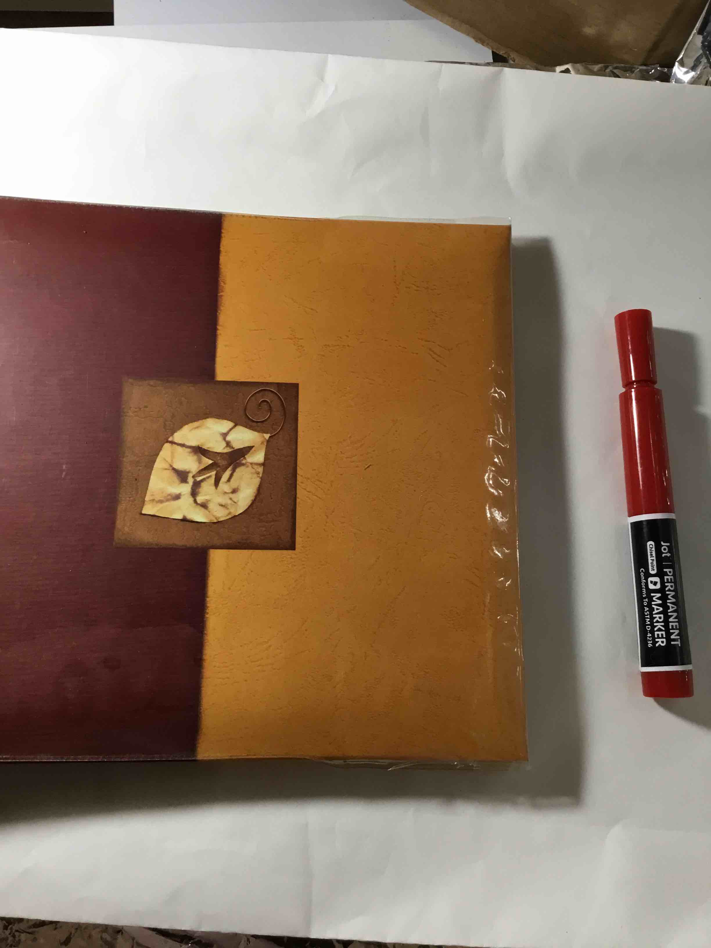 Photo album with a leaf motif on the cover