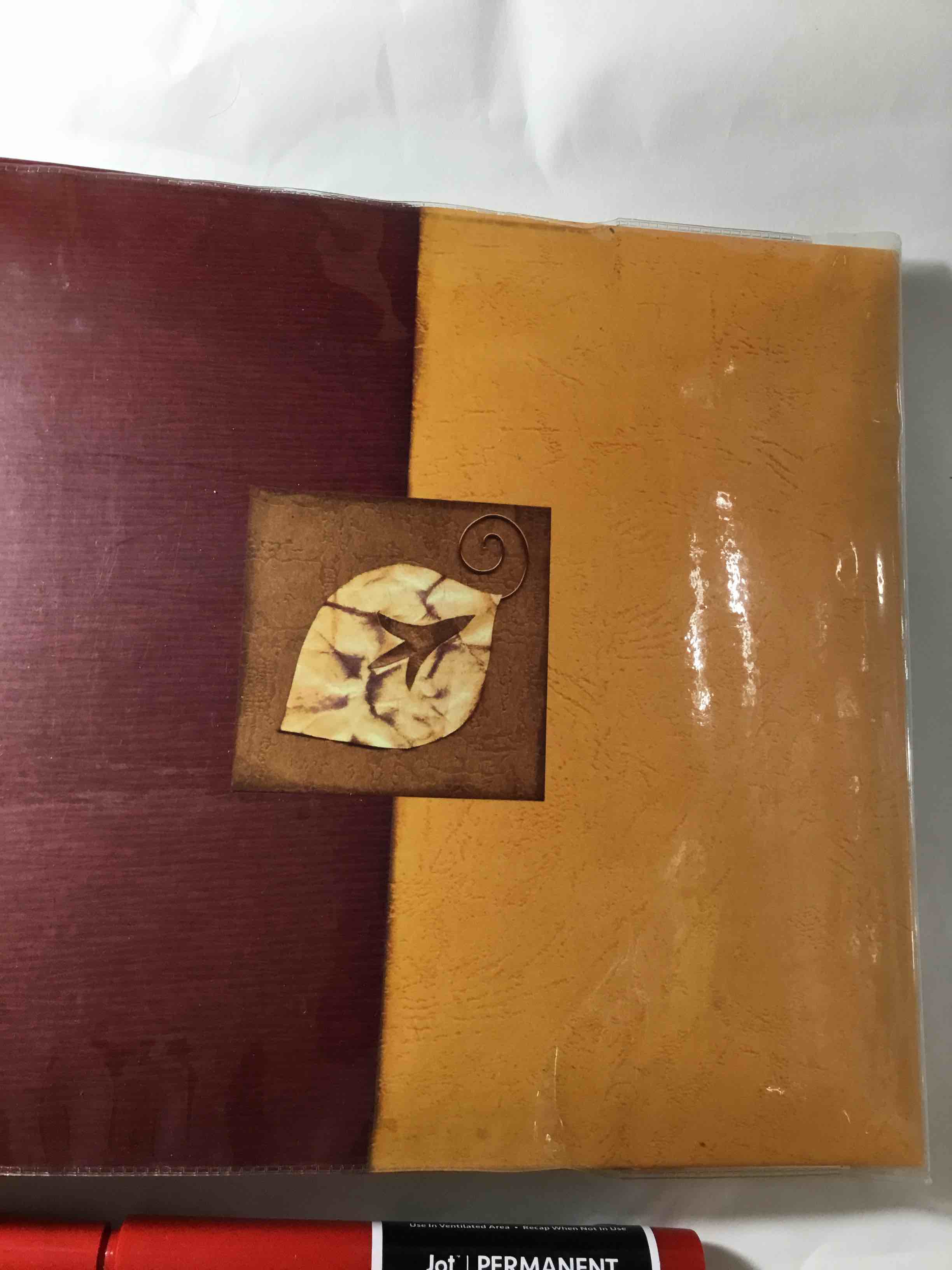 Photo album with a leaf motif on the cover