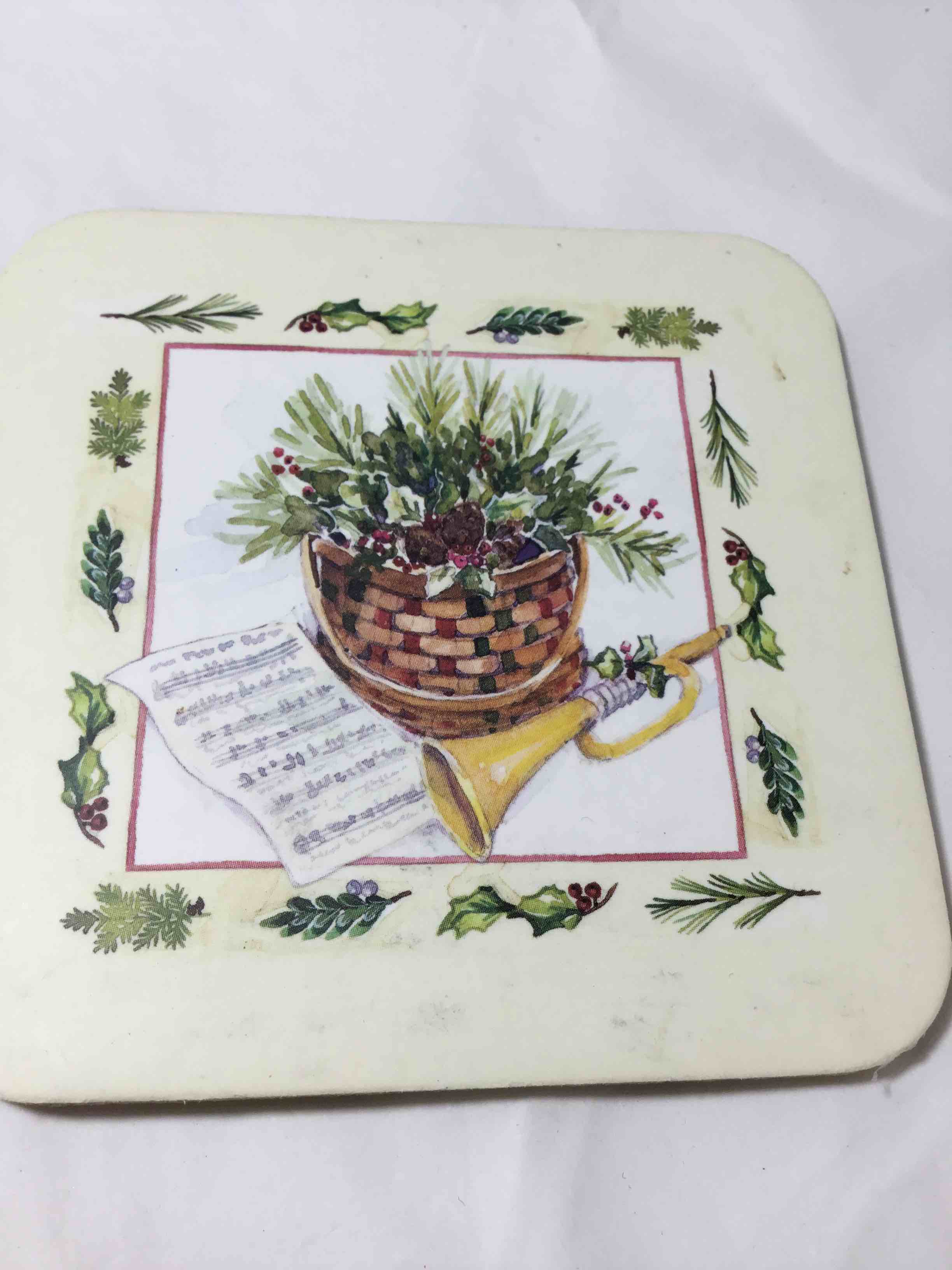 Longaberger Coaster featuring a Christmas basket and horn design