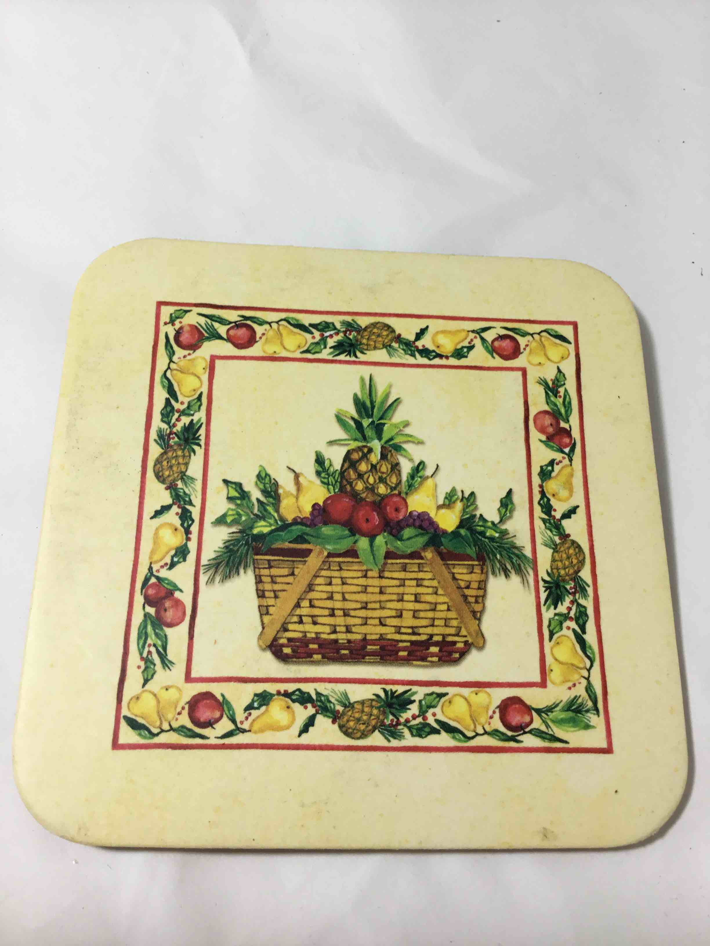 Longaberger Coaster featuring a Christmas basket and fruit design