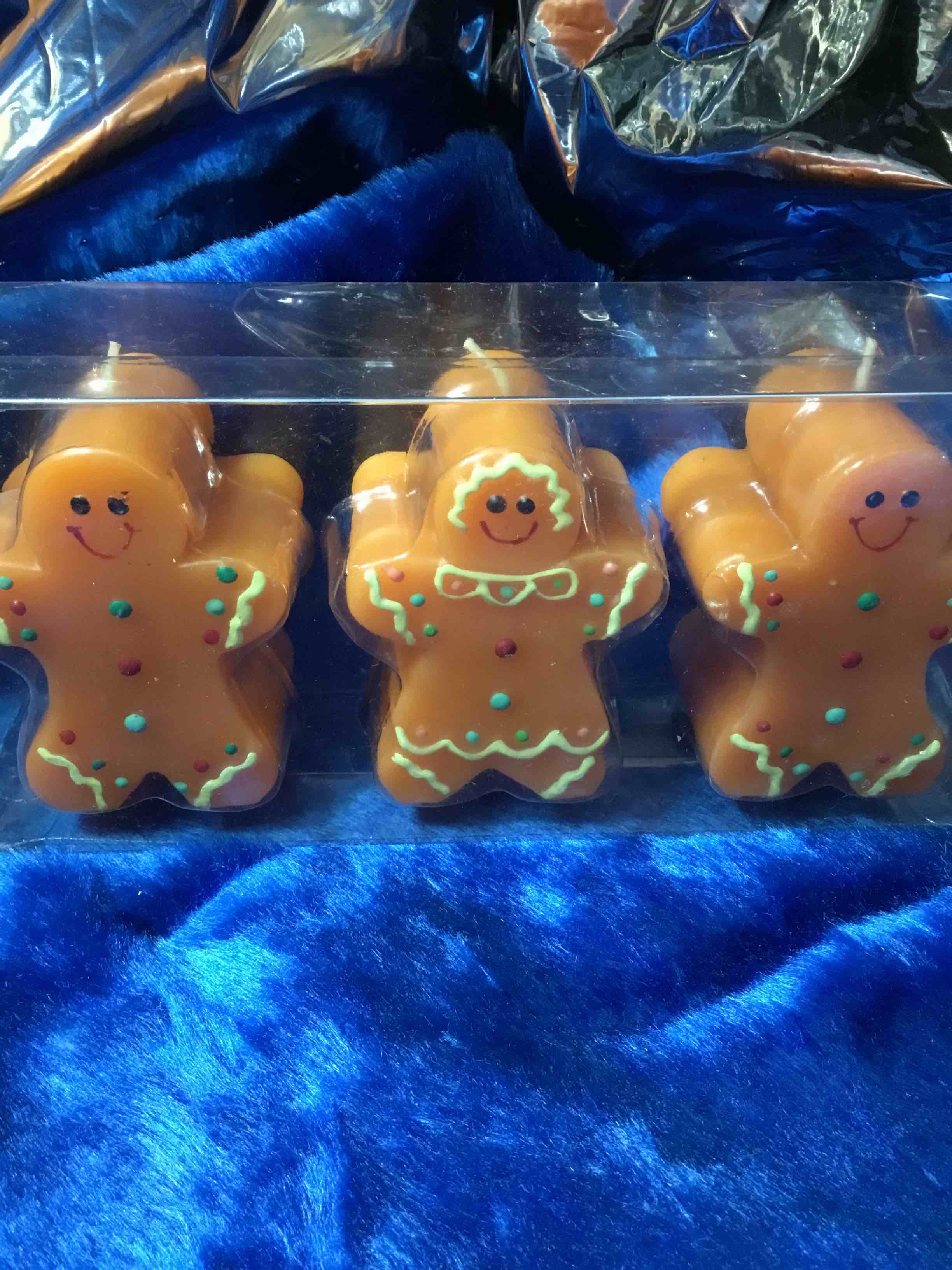 Set of three gingerbread man-shaped candles