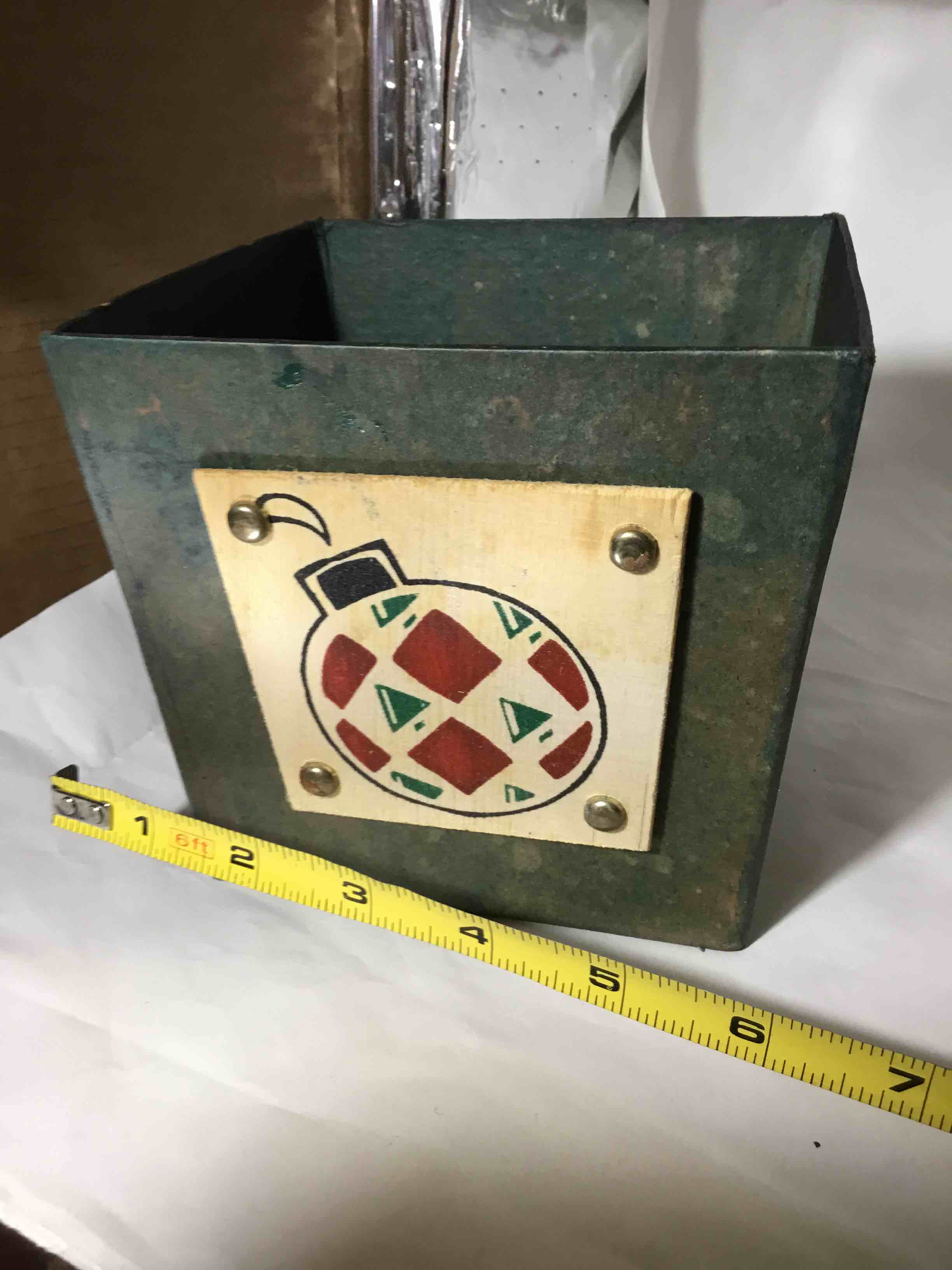 Composite material container Christmas ornament on front