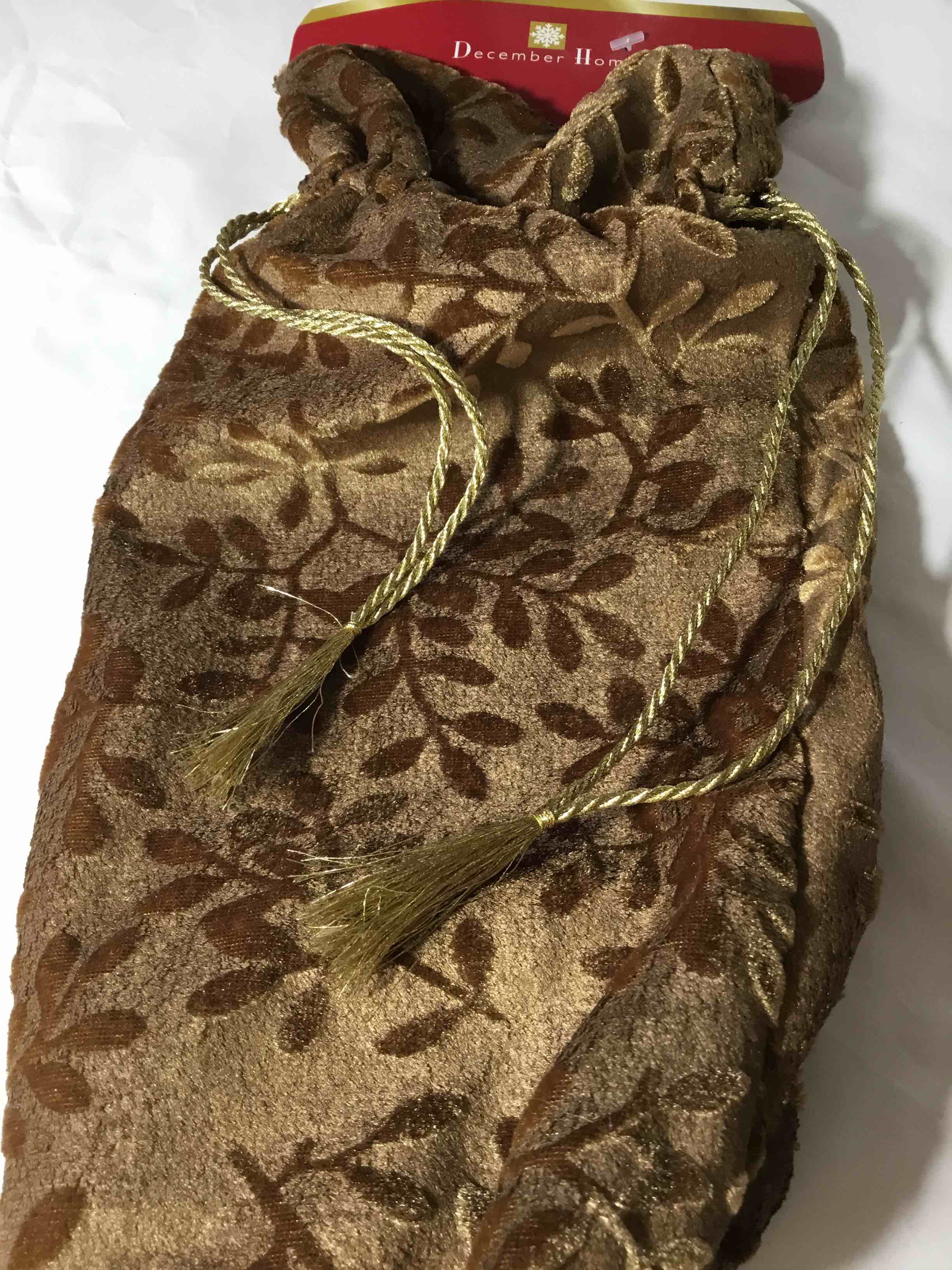 Velvet wine bottle gift bag in chocolate brown with a leaf pattern and gold drawstring tassels