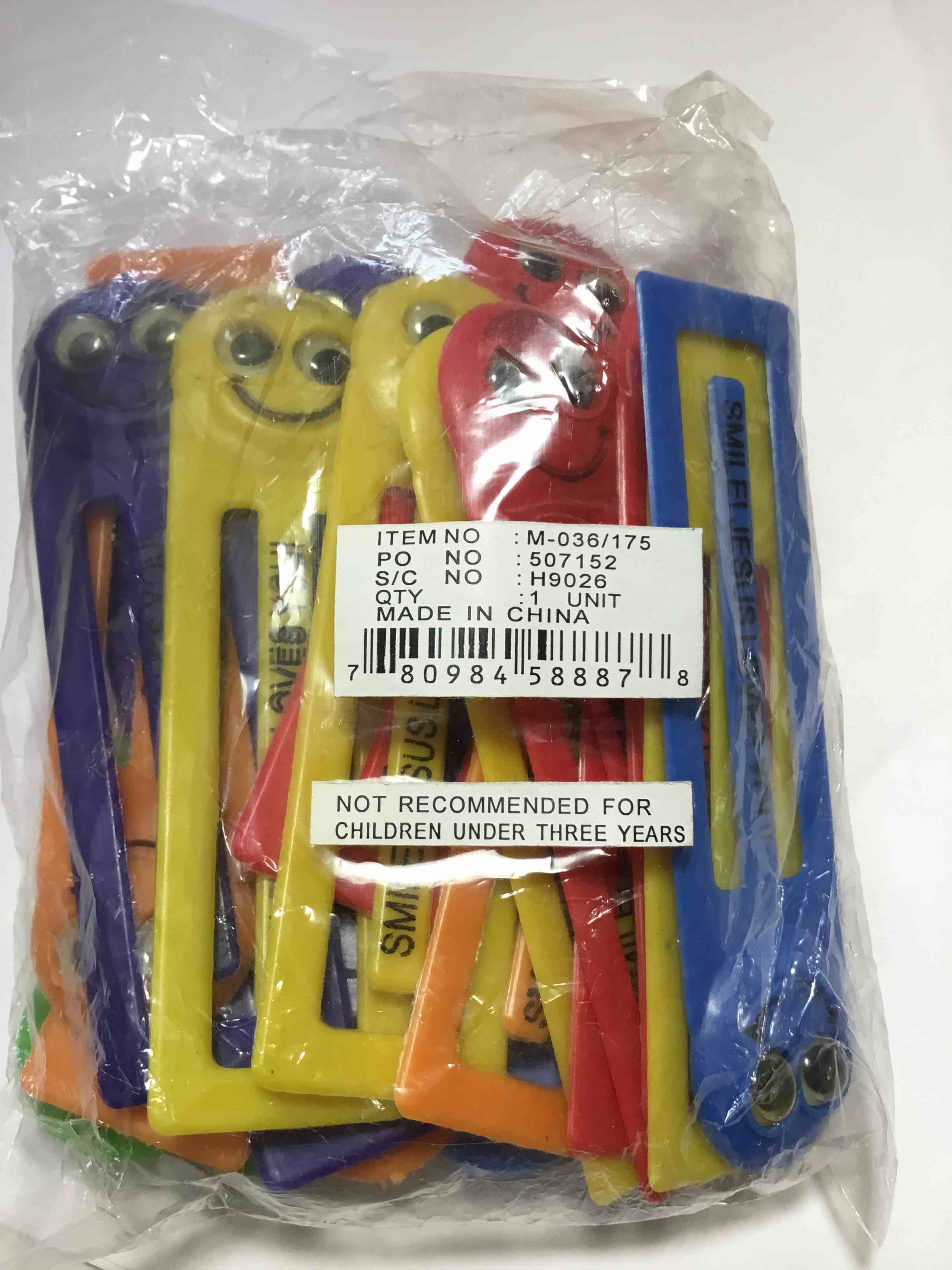 Set of plastic clips with googly eyes and the text "SMILE! JESUS LOVES YOU!" printed on them