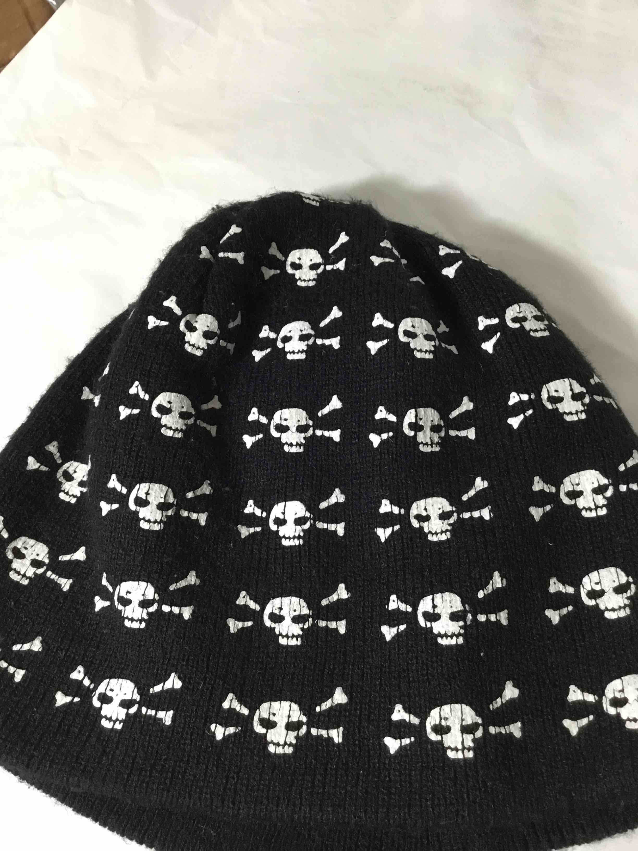 Black knit beanie with a white skull and crossbones pattern
