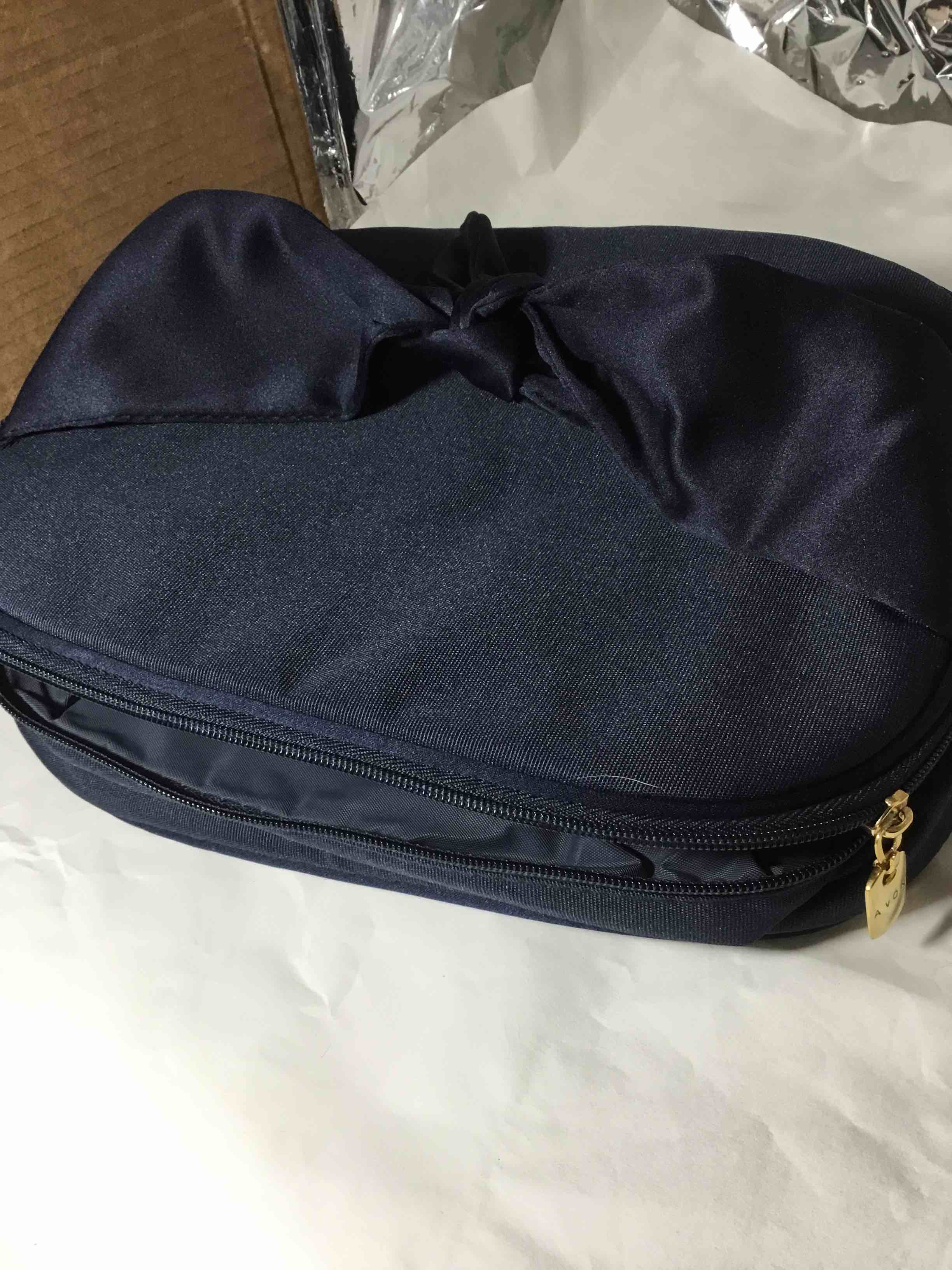 Navy blue Avon cosmetic or toiletry bag with a golden zipper pull