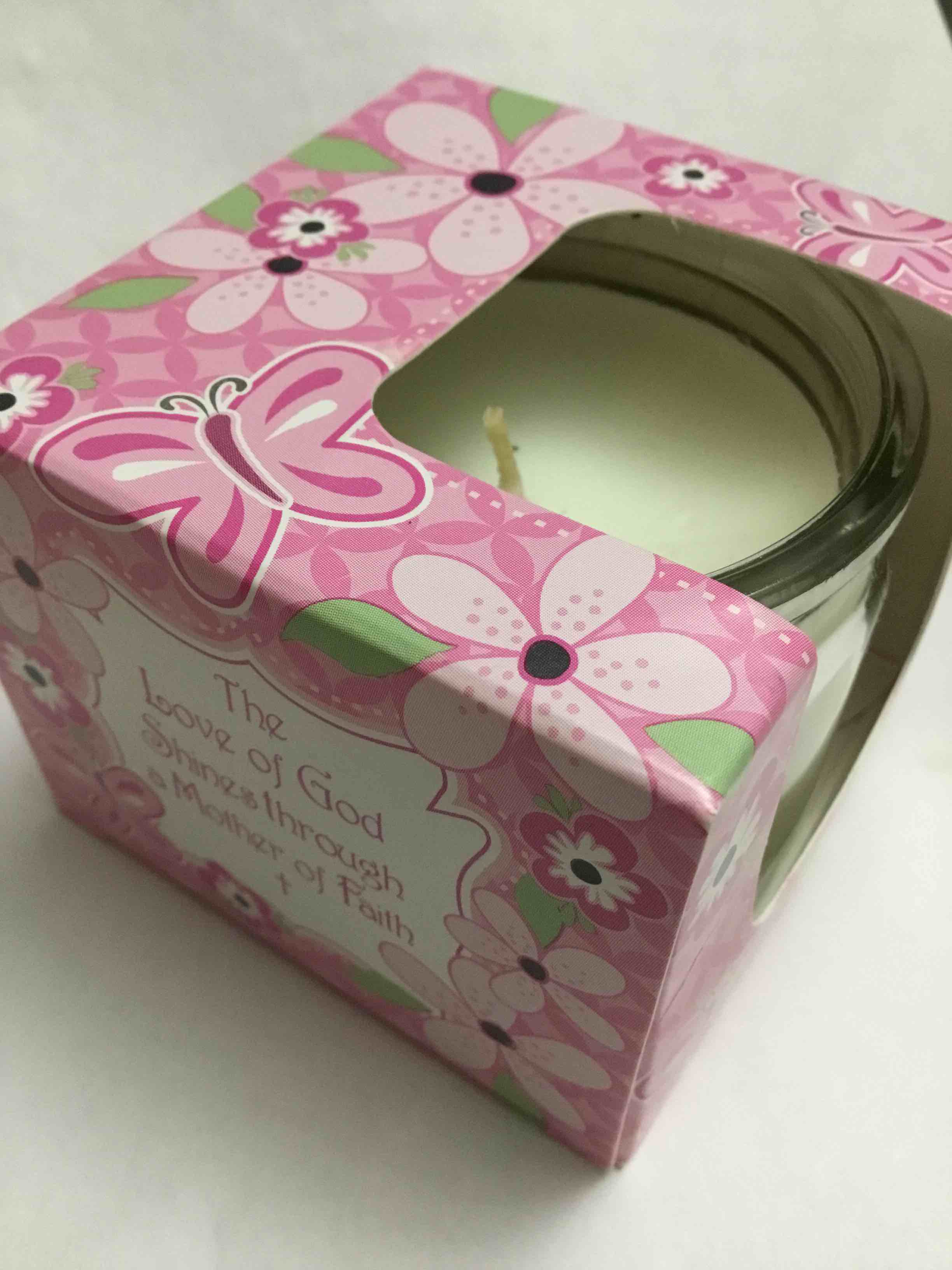 Candle in a glass jar, presented in a decorative pink gift box with floral patterns