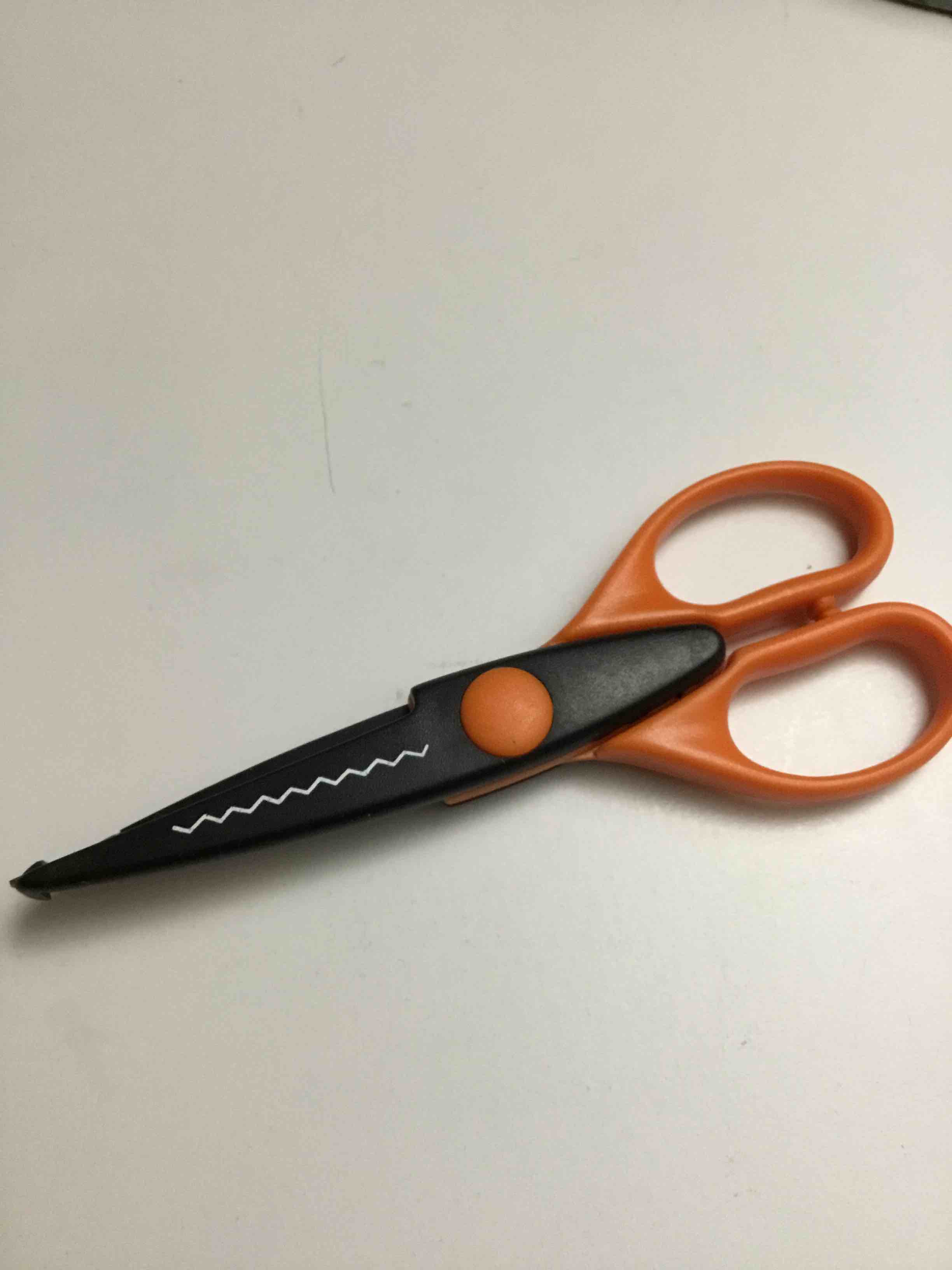 Scissors create a wavy or "scallop" pattern,paper edger scissors, used for craft projects