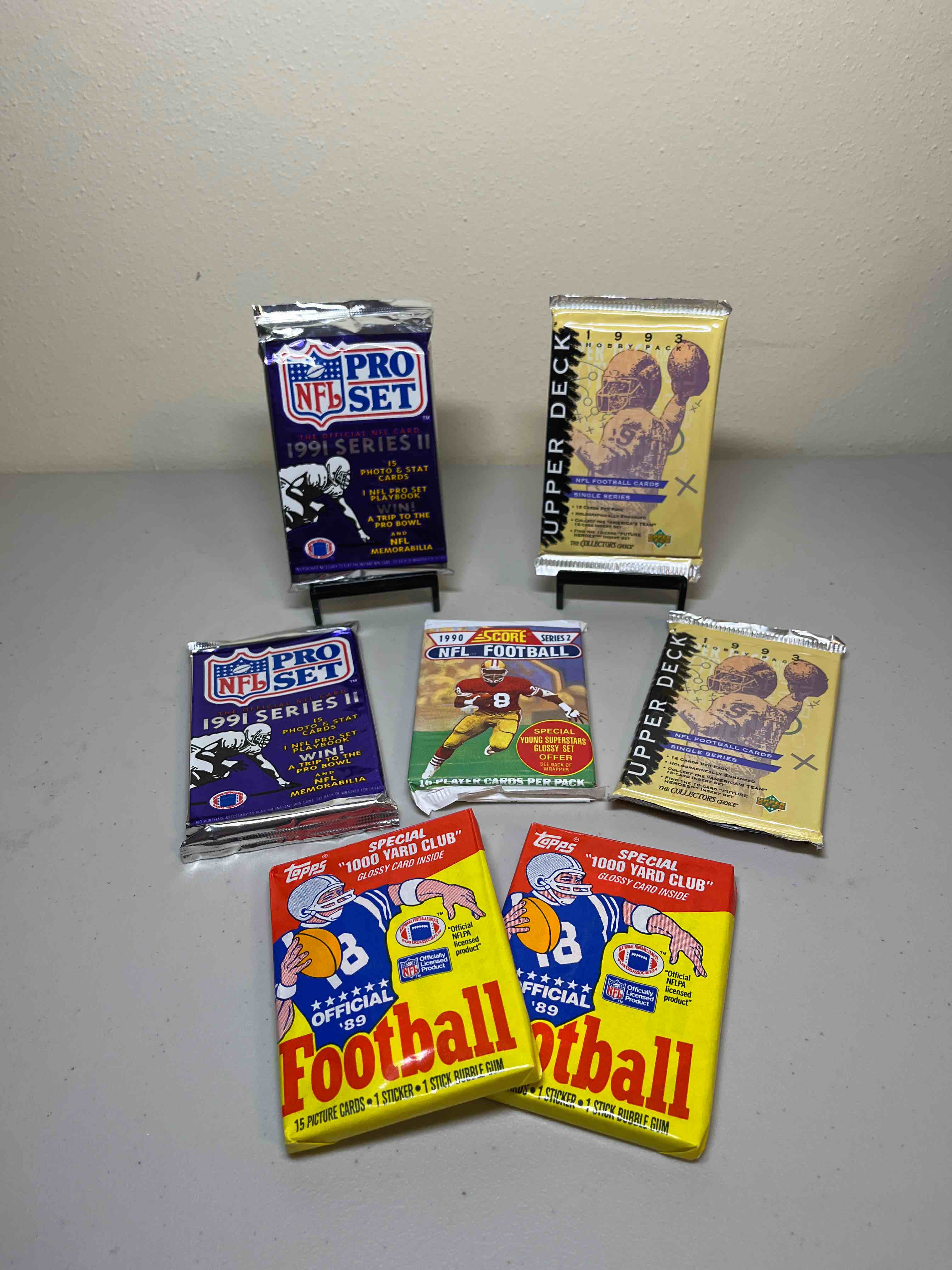 (7) Sealed Mixed ‘80s & ‘90s Football Packs- Sealed Packs! Upper Deck, Score, NFL Pro Set, and (2) 1989 Topps!! WOW! Look for Rookies, Stars, and Rare Inserts!