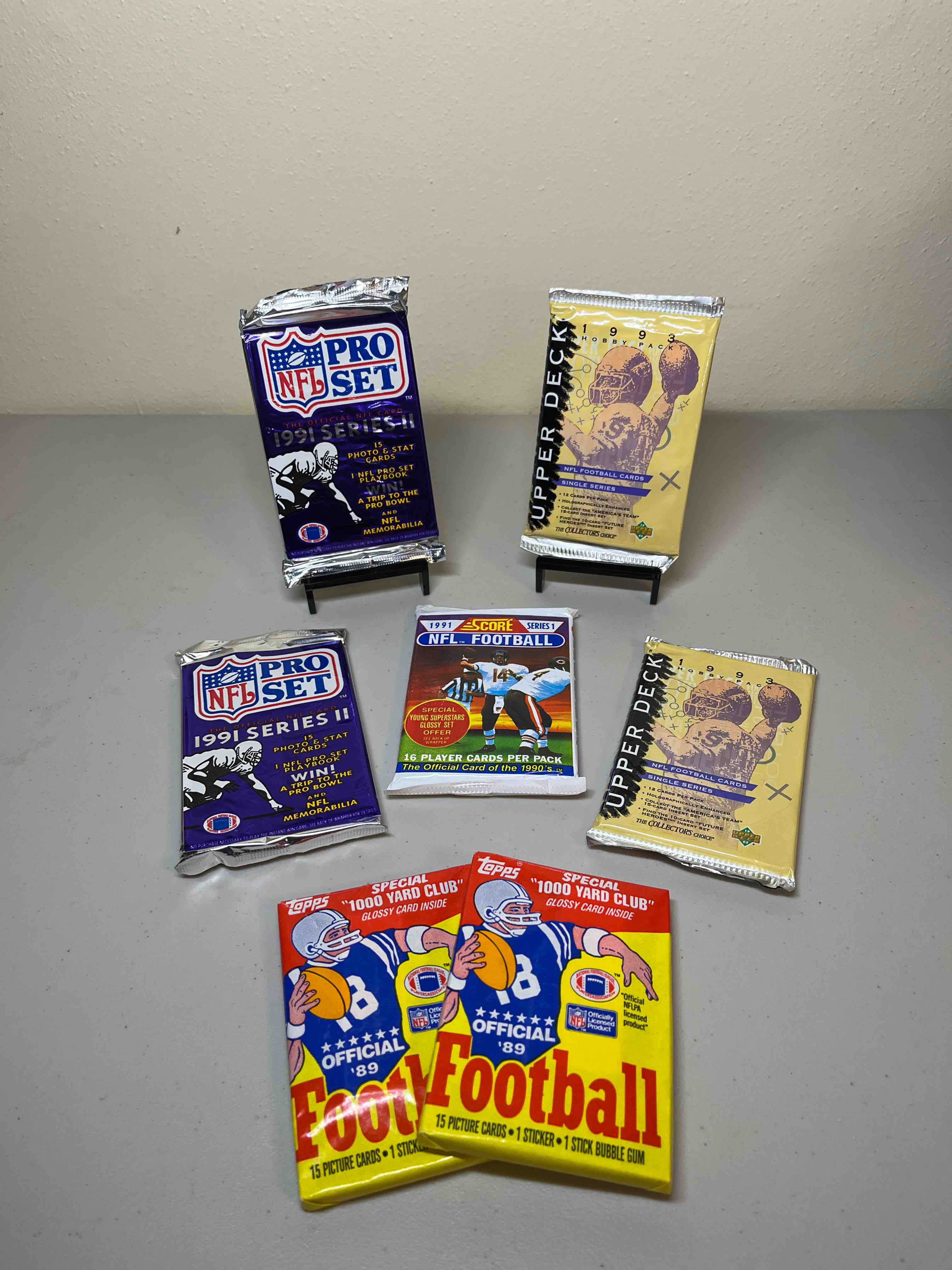 (7) Sealed Mixed ‘80s & ‘90s Football Packs- Sealed Packs! Upper Deck, Score, NFL Pro Set, and (2) 1989 Topps!! WOW! Look for Rookies, Stars, and Rare Inserts
