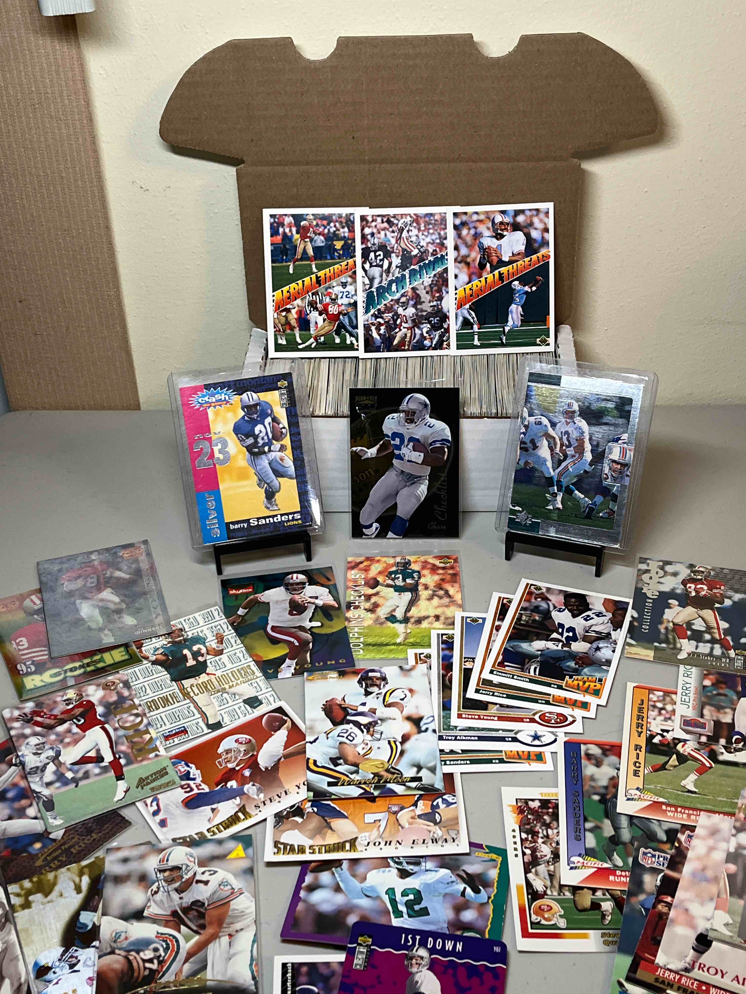 400ct. lot Mixed 90’s Football Cards- What an amazing lot! Star Quarterbacks Dan Marino, John Elway, Steve Young & Troy Aikman! Running Backs Emmitt Smith and Barry Sanders!! Jerry Rice & JJ Stokes!! Check these out!