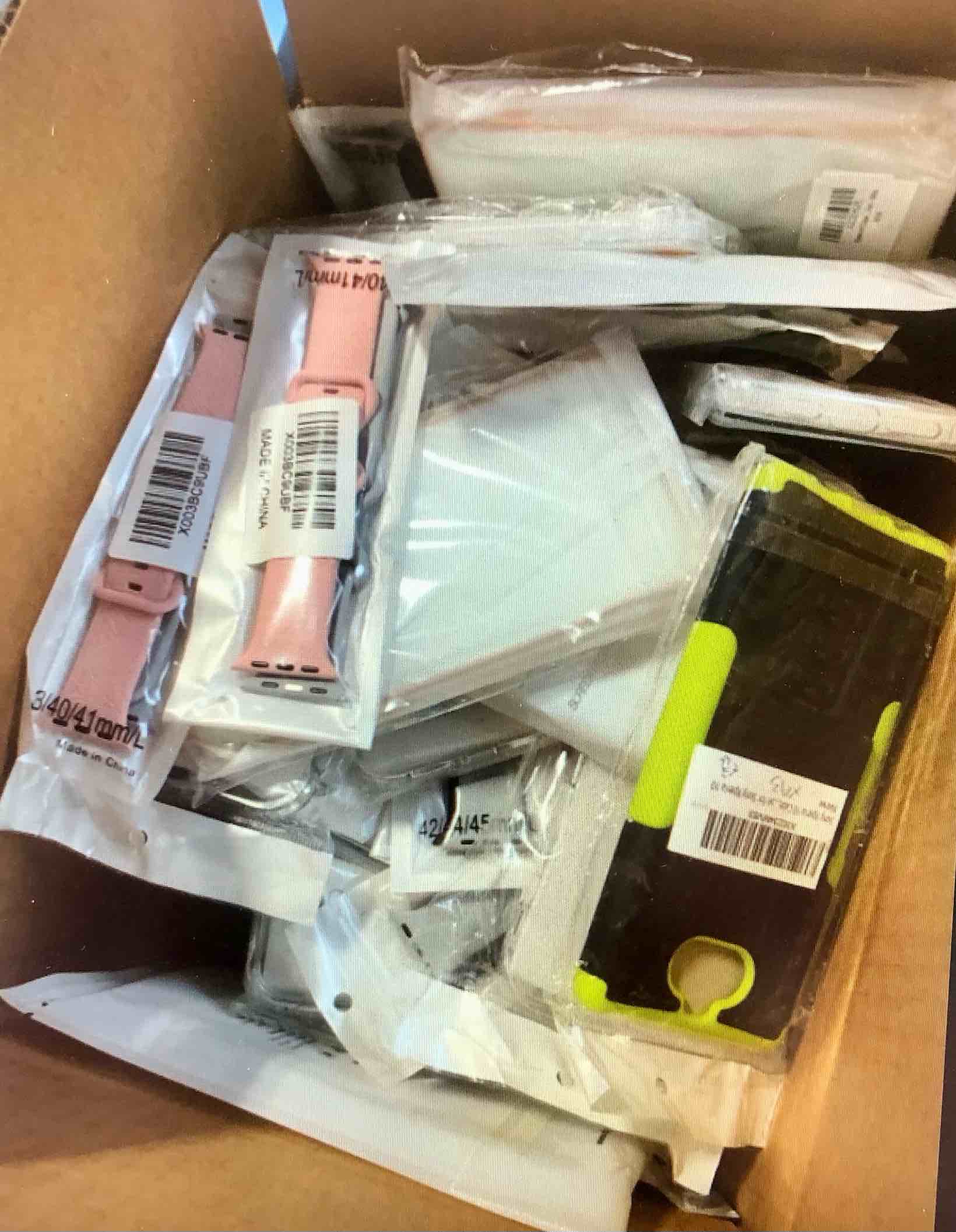 Box of assorted phone cases and watch bands