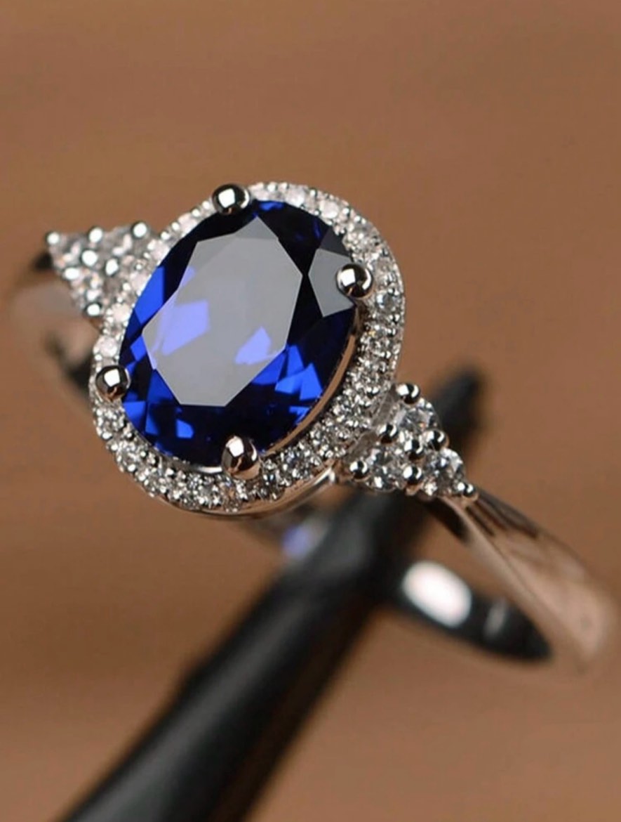 Blue Topez halo ring in silver settings (size 8)