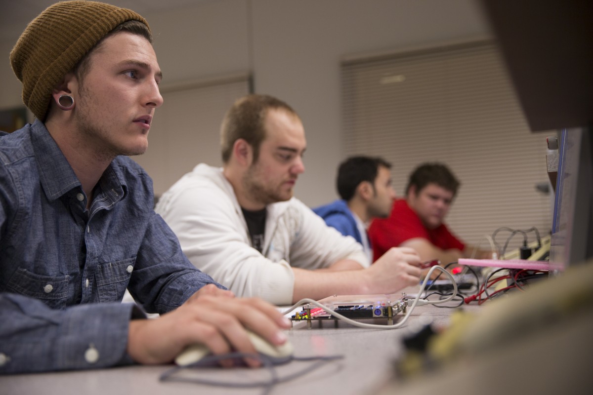 Students working with a circuit at a desk