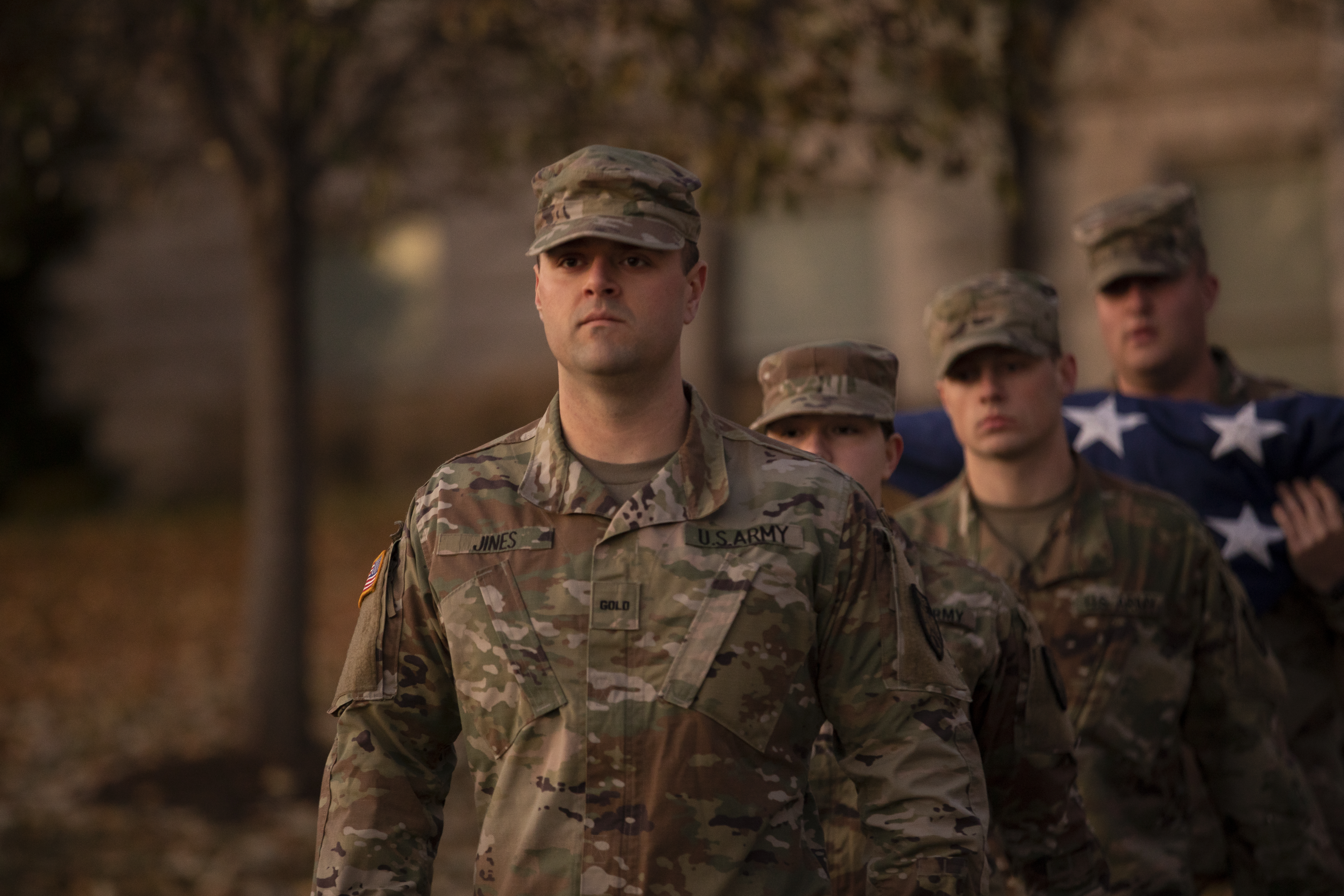 Image of 4 military members at a flag ceremony.