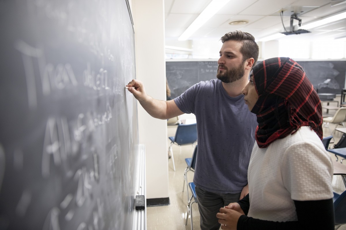 A man and a woman working together on a math problem.