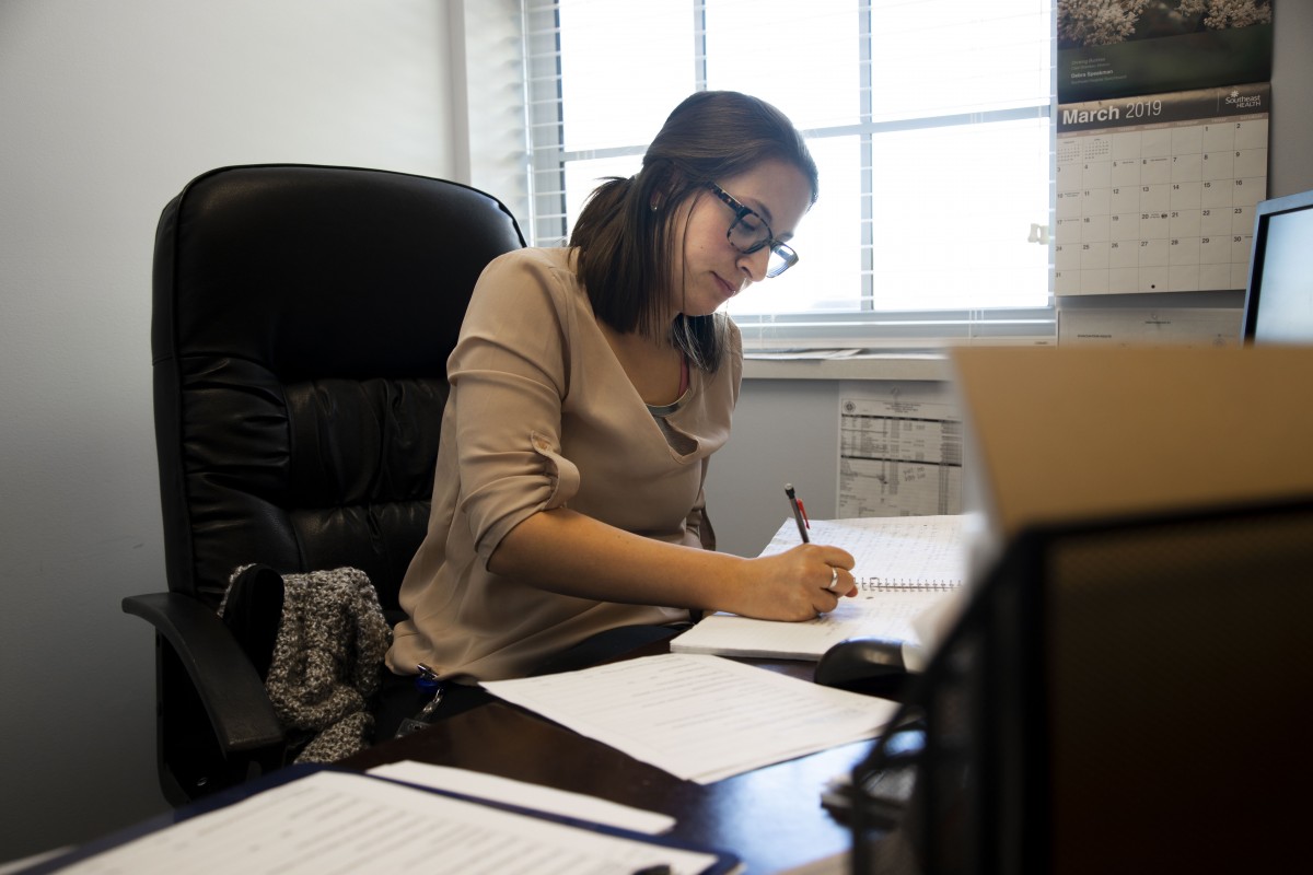 A woman working diligently at her desk