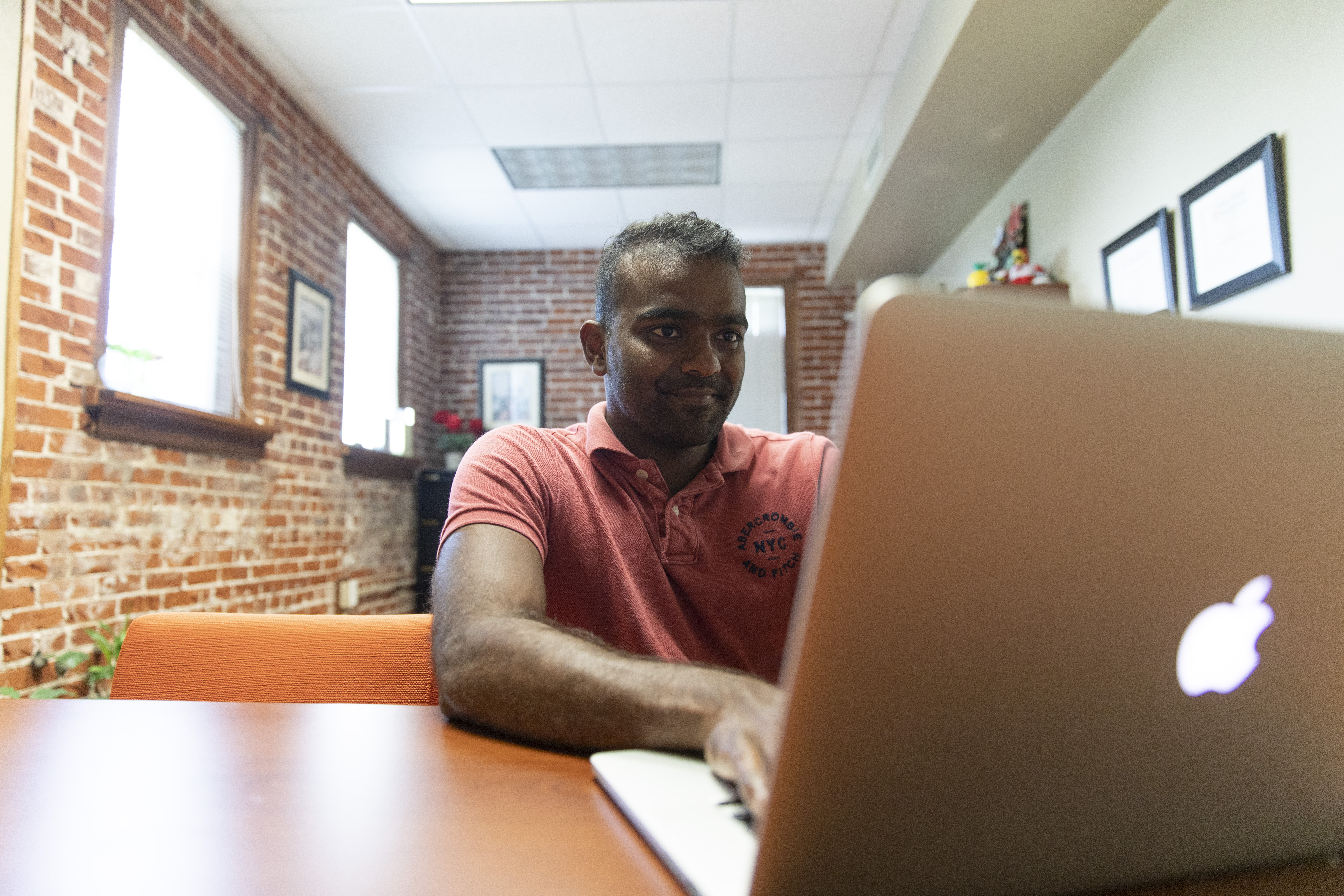 Image of a man working on a computer.