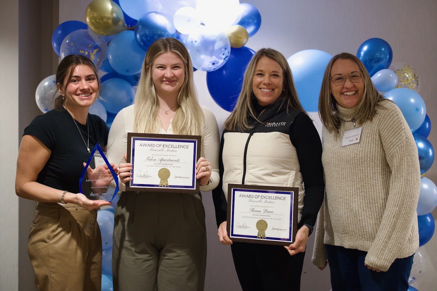 Avante Properties team holding Awards of Excellence certificates and trophy at industry awards event in Wisconsin