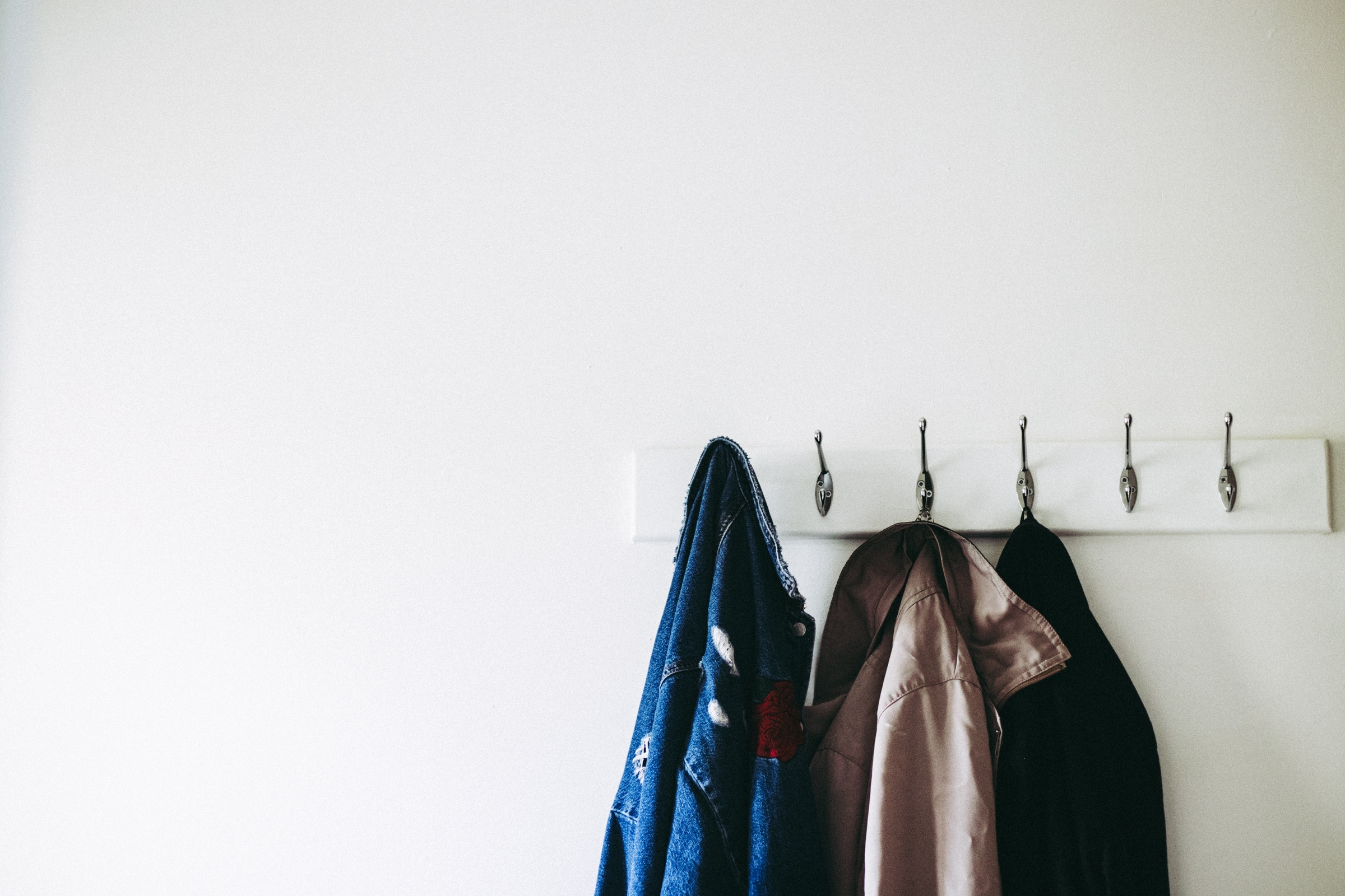 Coats hanging on wall hooks