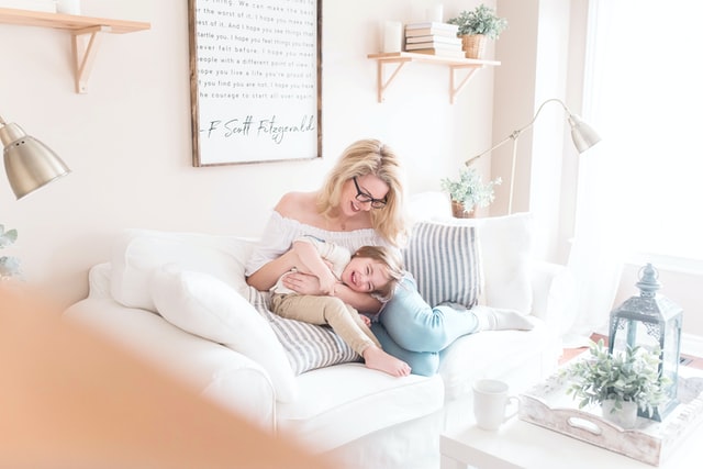 Mom and child sitting on a sofa
