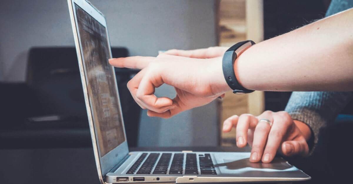 Pointing at laptop screen